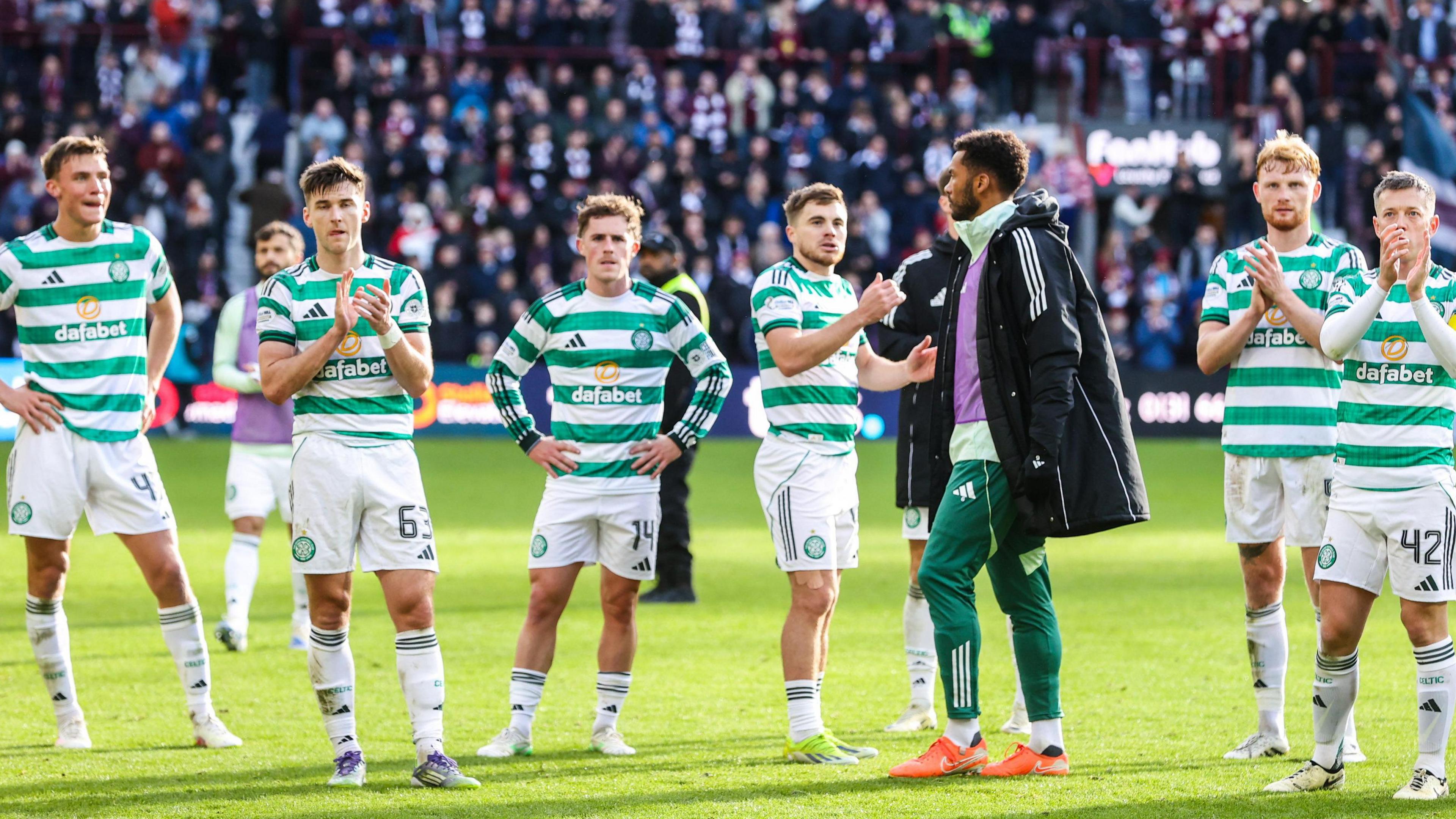 Celtic players applauding supporters