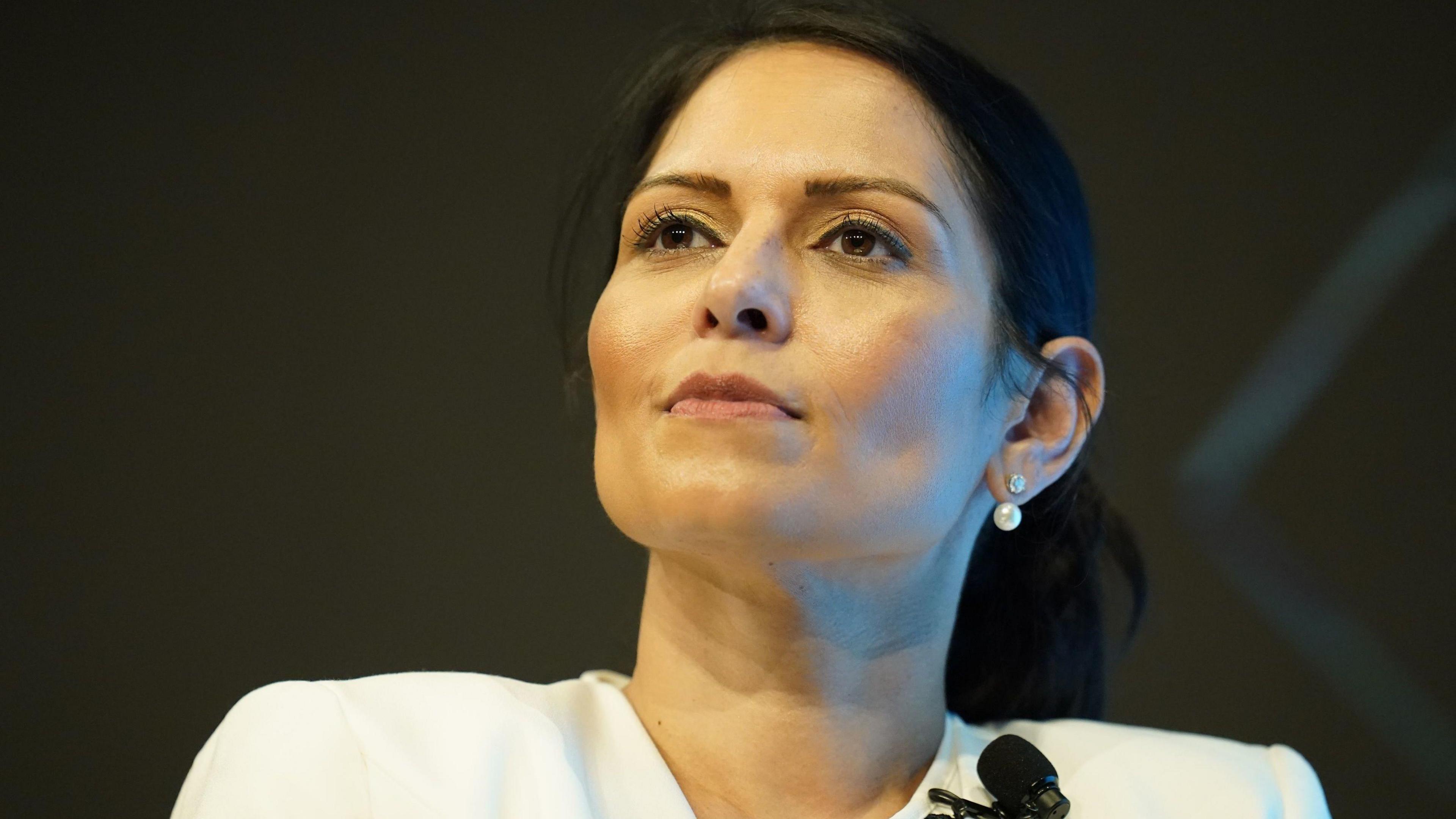 Priti Patel wearing a white dress