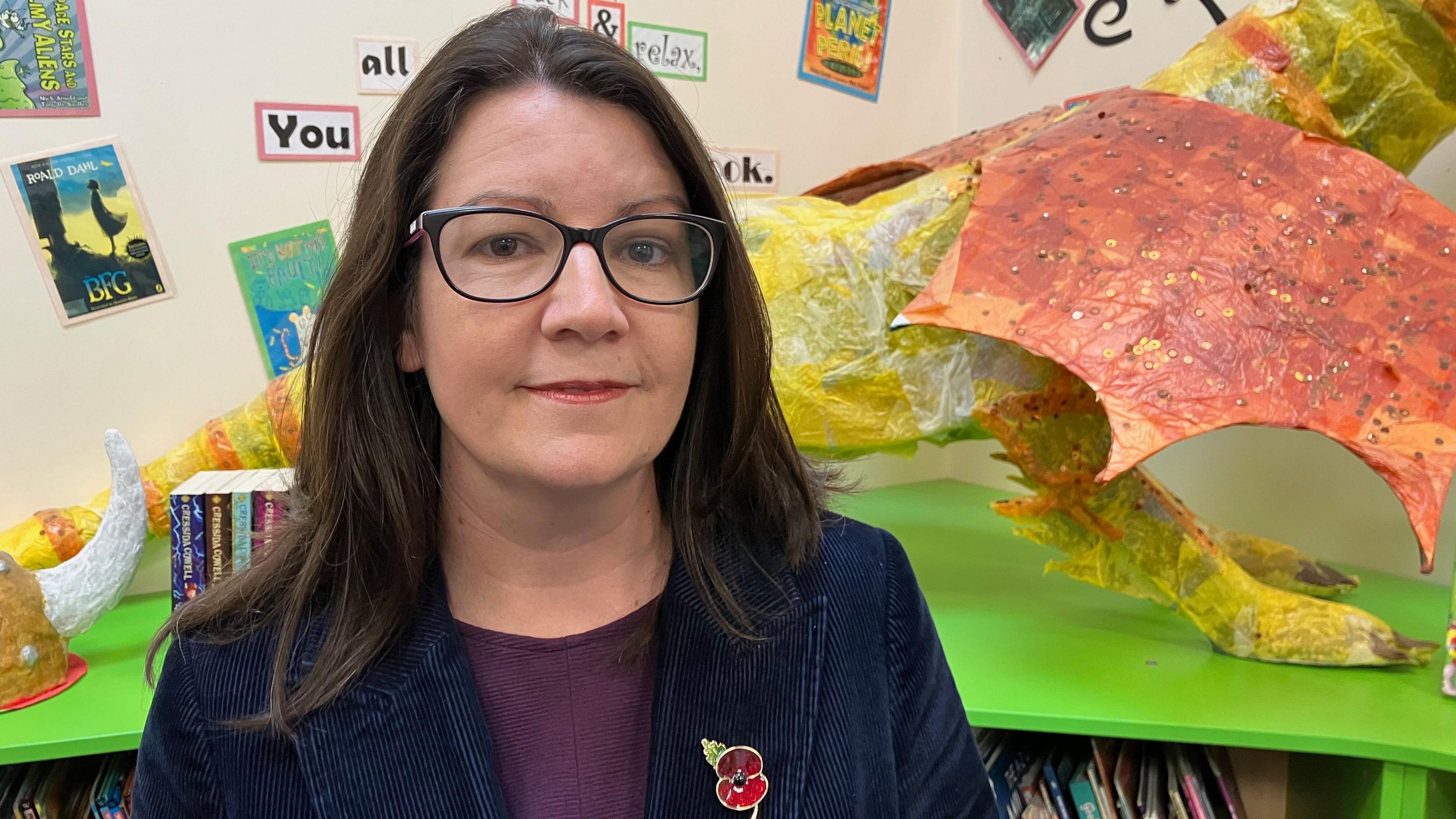 Amy Leather, Deputy Head of Willand School standing inthe school library