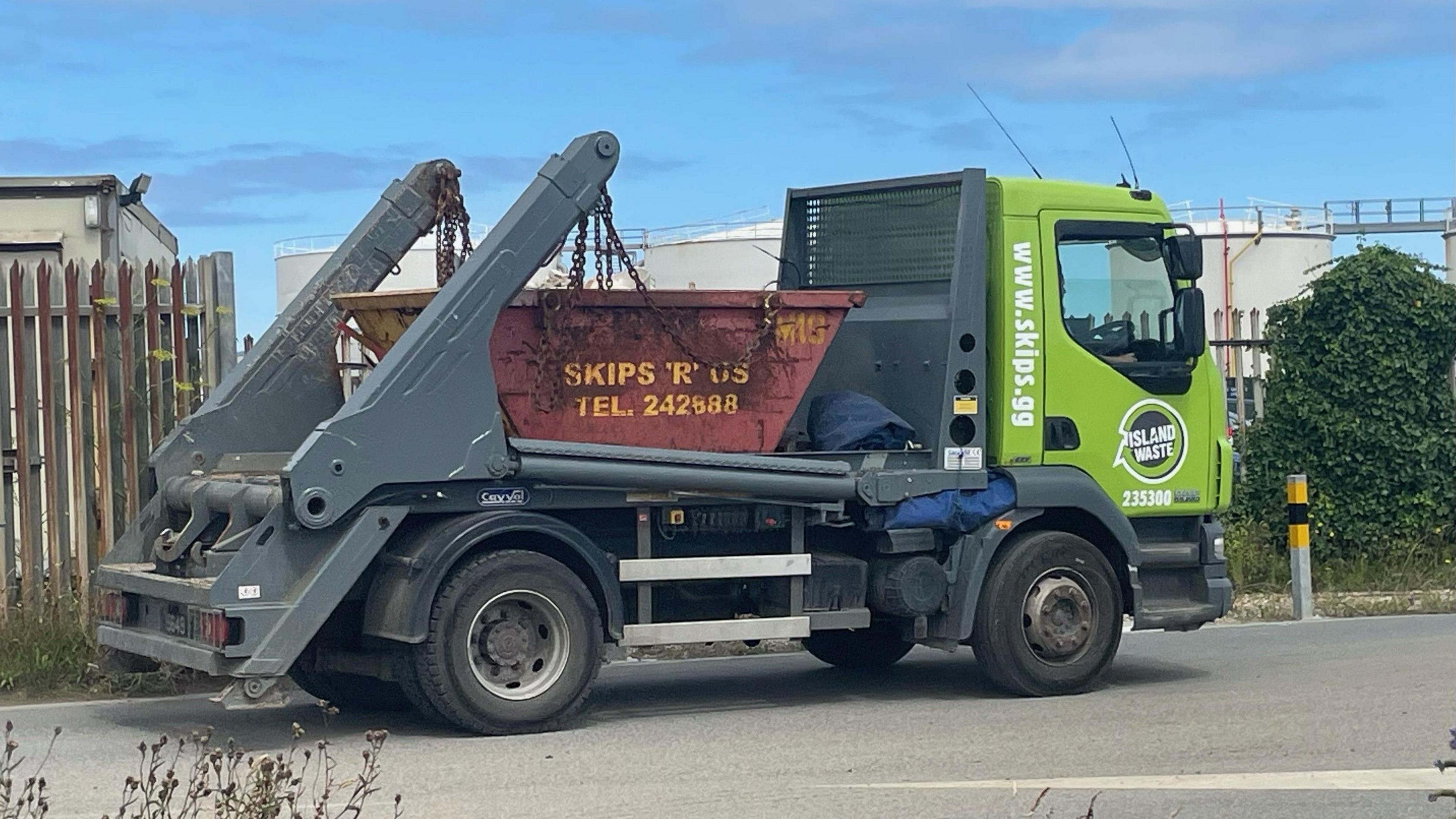 A builders truck carrying a skip