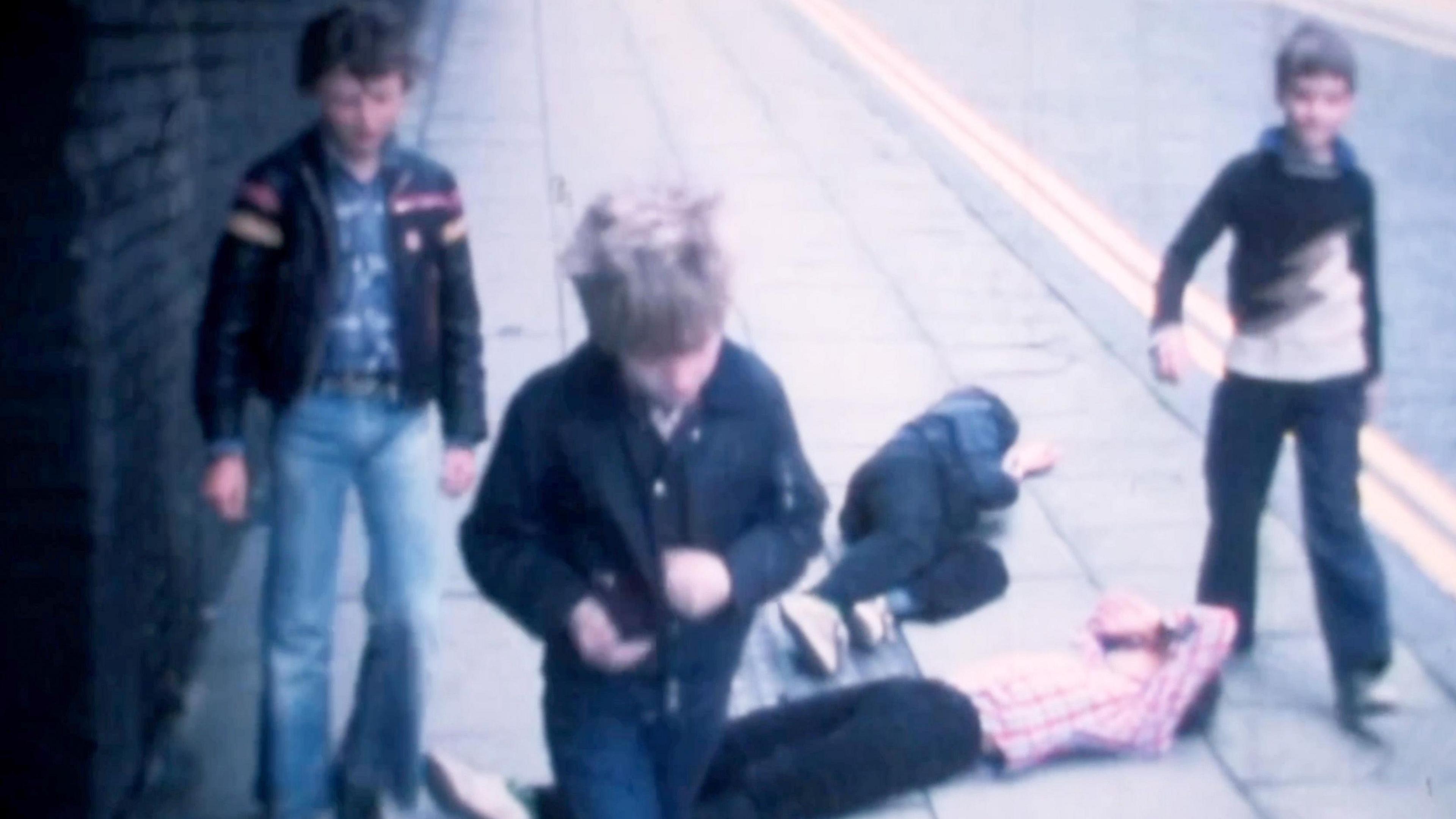 Still of a cine film showing five teenagers (left to right) Ian Sallery, Paul Birchall, Paul Sudbury, John Tyson, and Tony Gandy - with two lying on the pavement - after a fight scene - filmed in 1978.