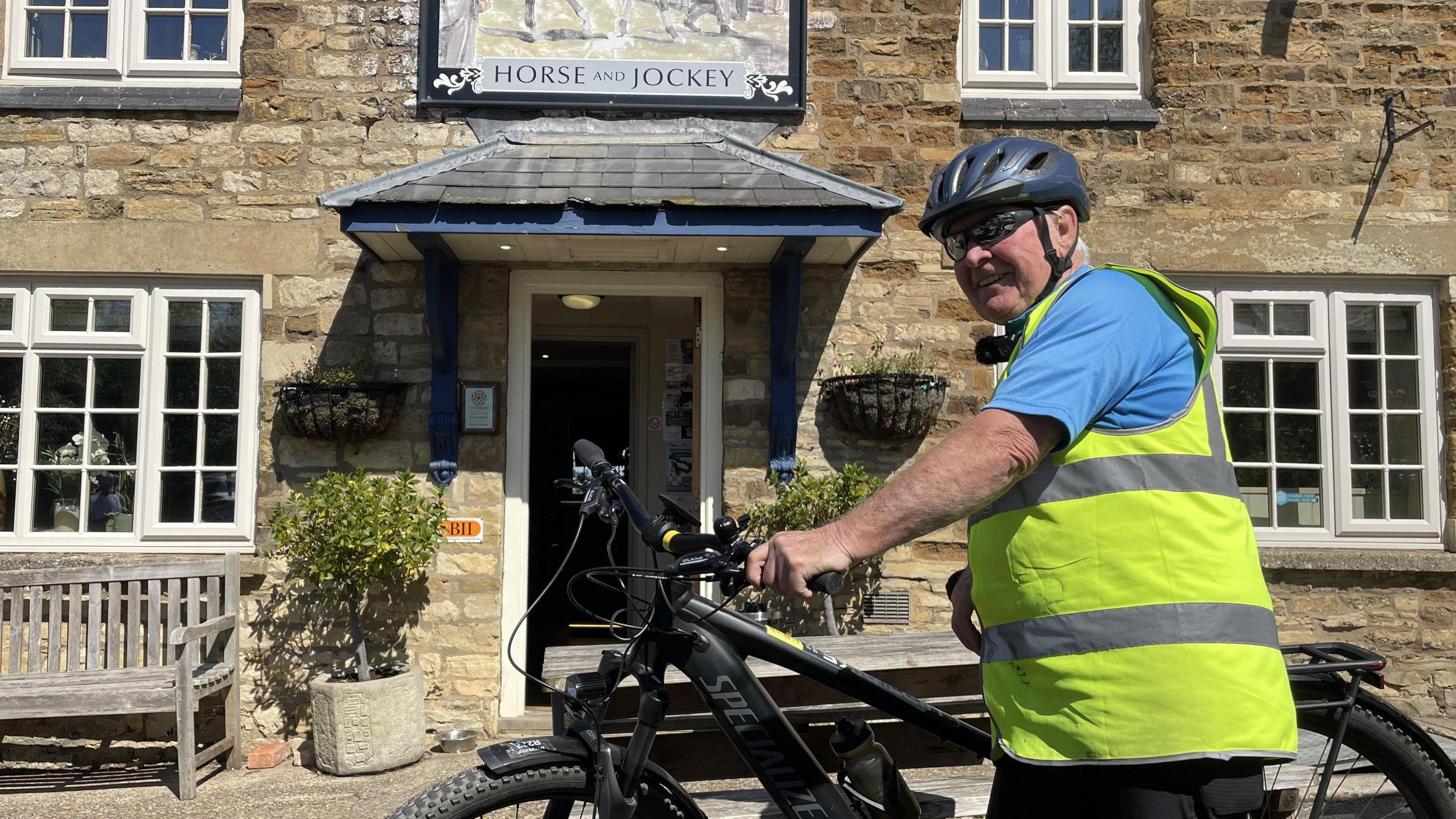 Frank McEwan with his bike outside the Horse and Jockey pub in Manton