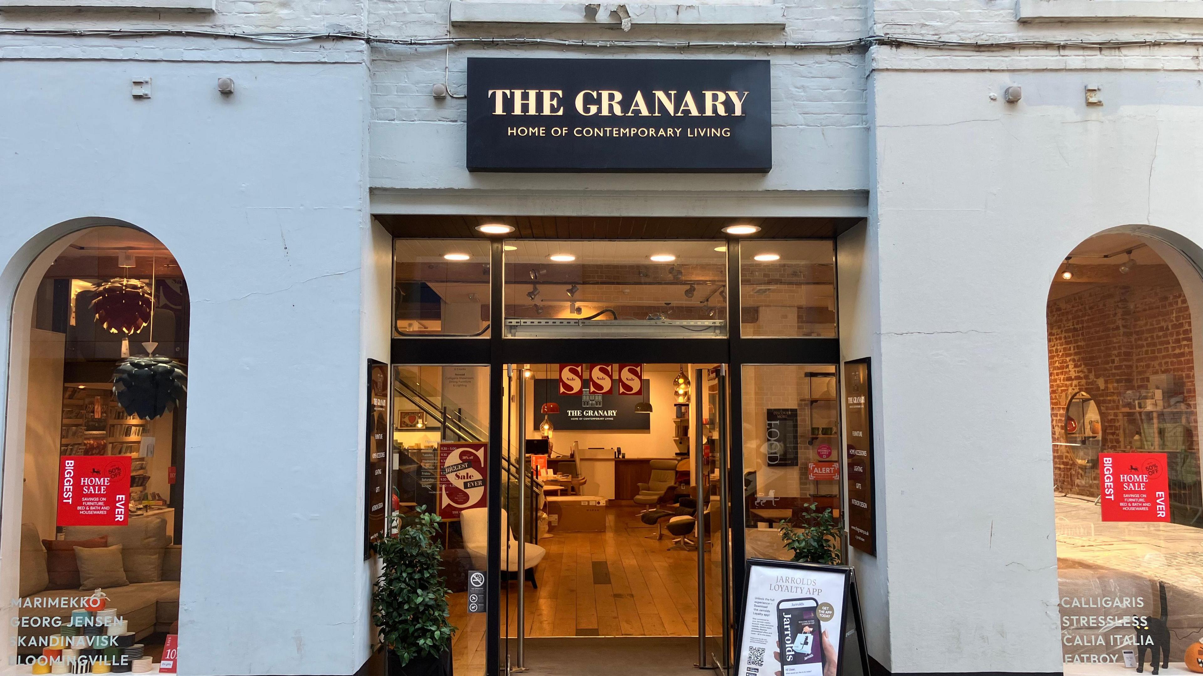 The outside of a shop with furniture inside, and a sign that says "The Granary, Home of Contemporary Living".