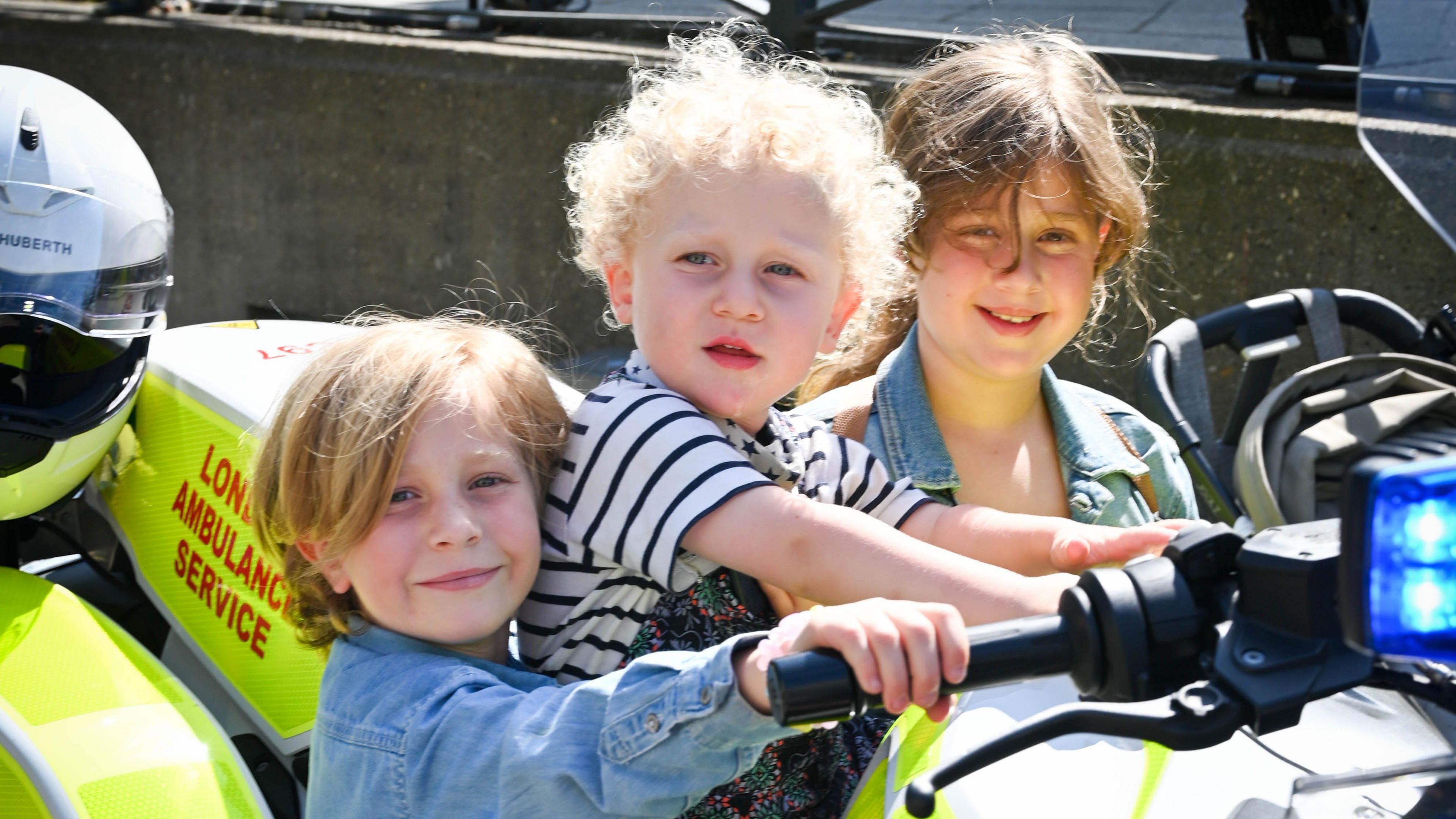 From left: Anouk, Gabriel and Farah on the London Ambulance motorcycle