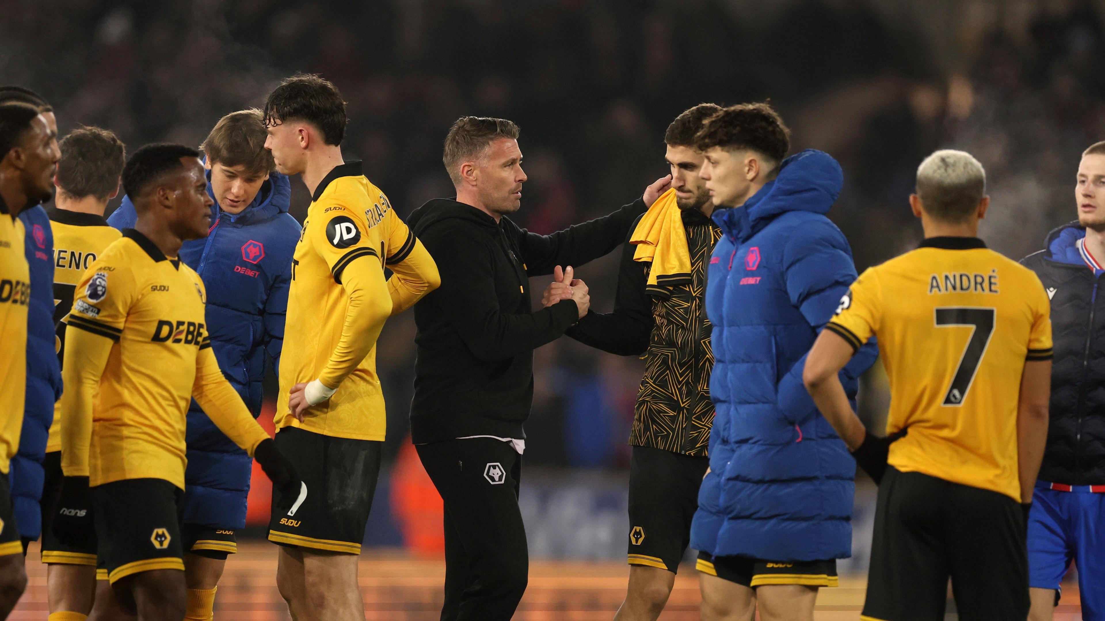 Rob Edwards consoles his Wolves players