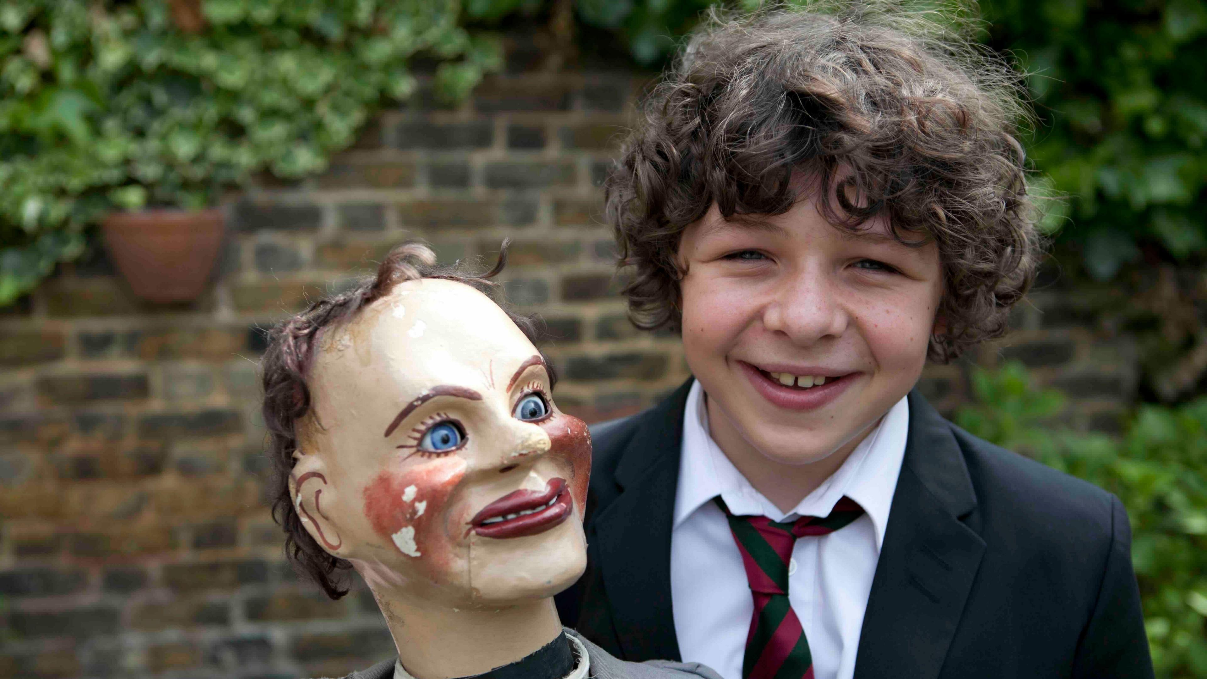 Daniel Roche holding a ventriloquist doll