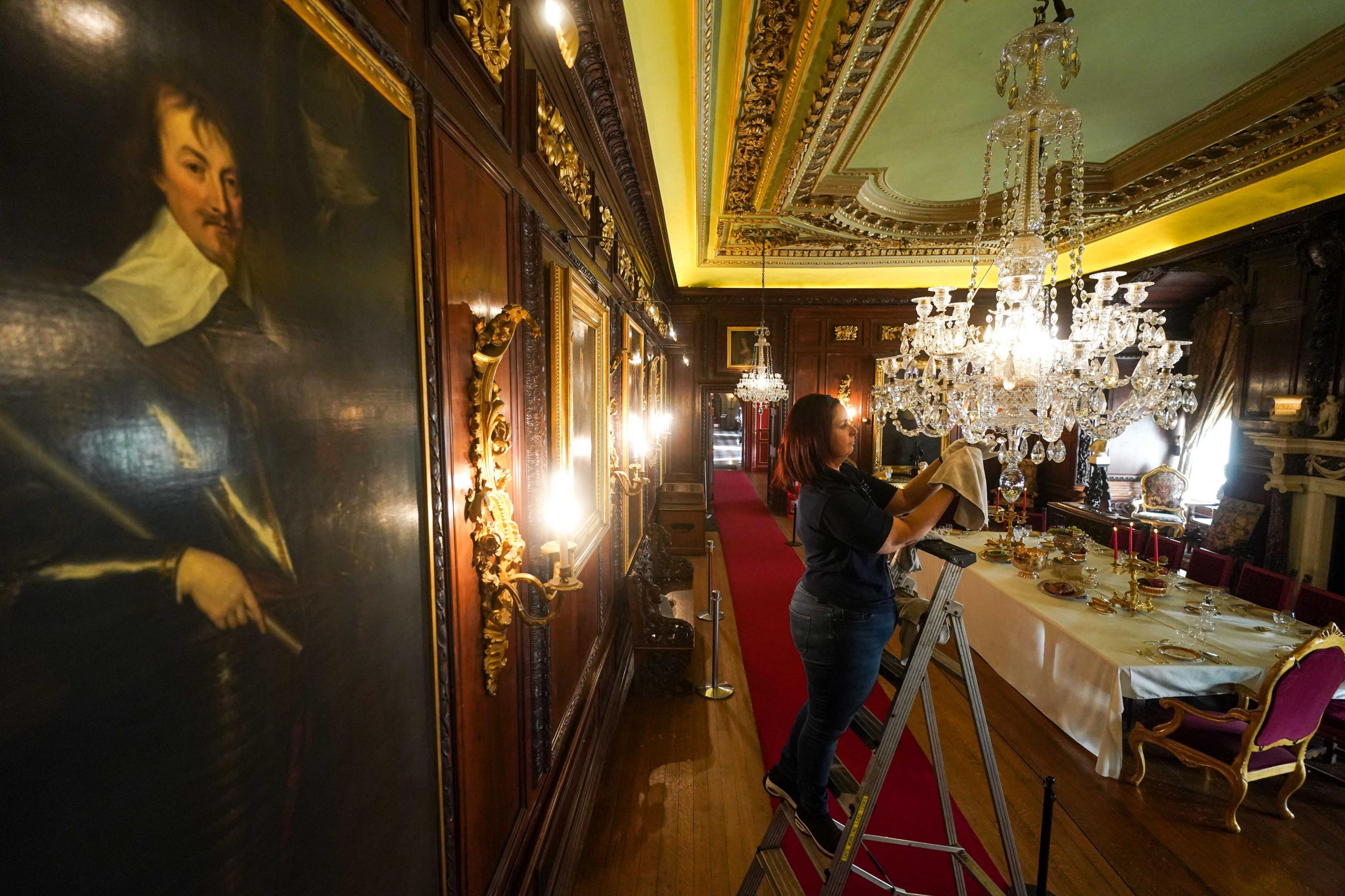 Woman cleaning chandelier