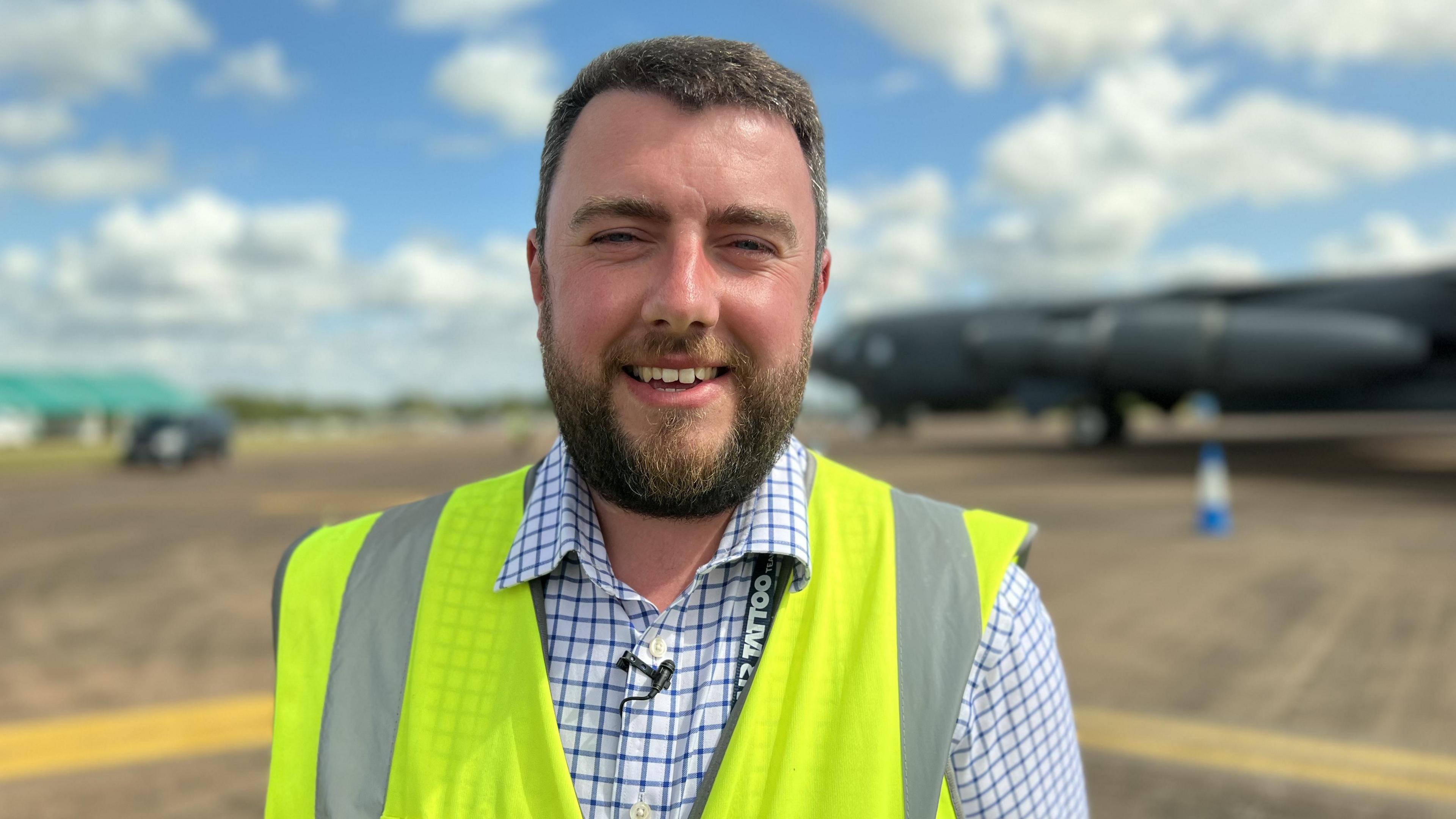 Peter Reoch in a high vis jacket with a blurred plan in the background