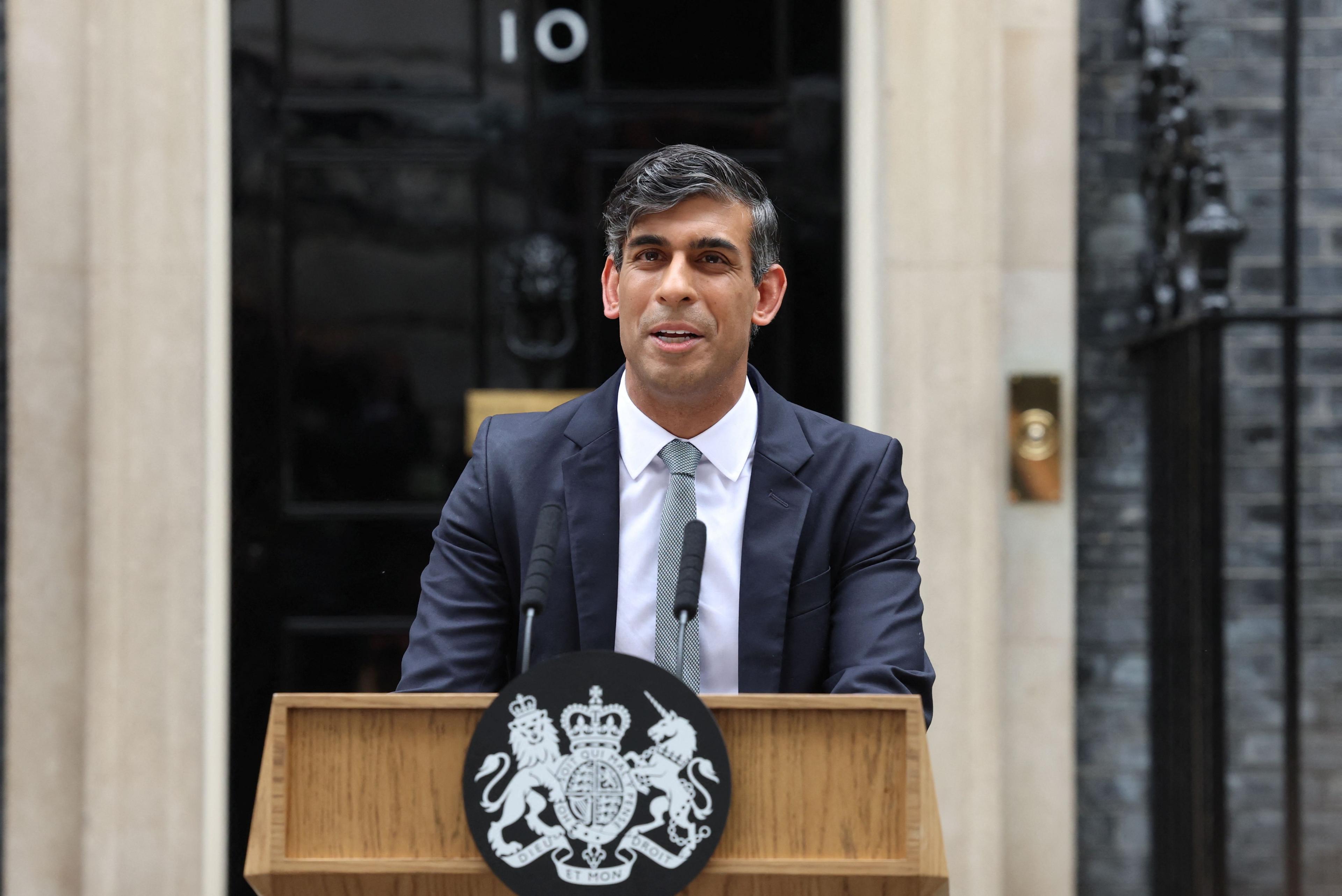 Rishi Sunak stands behind a podium giving his resignation speech