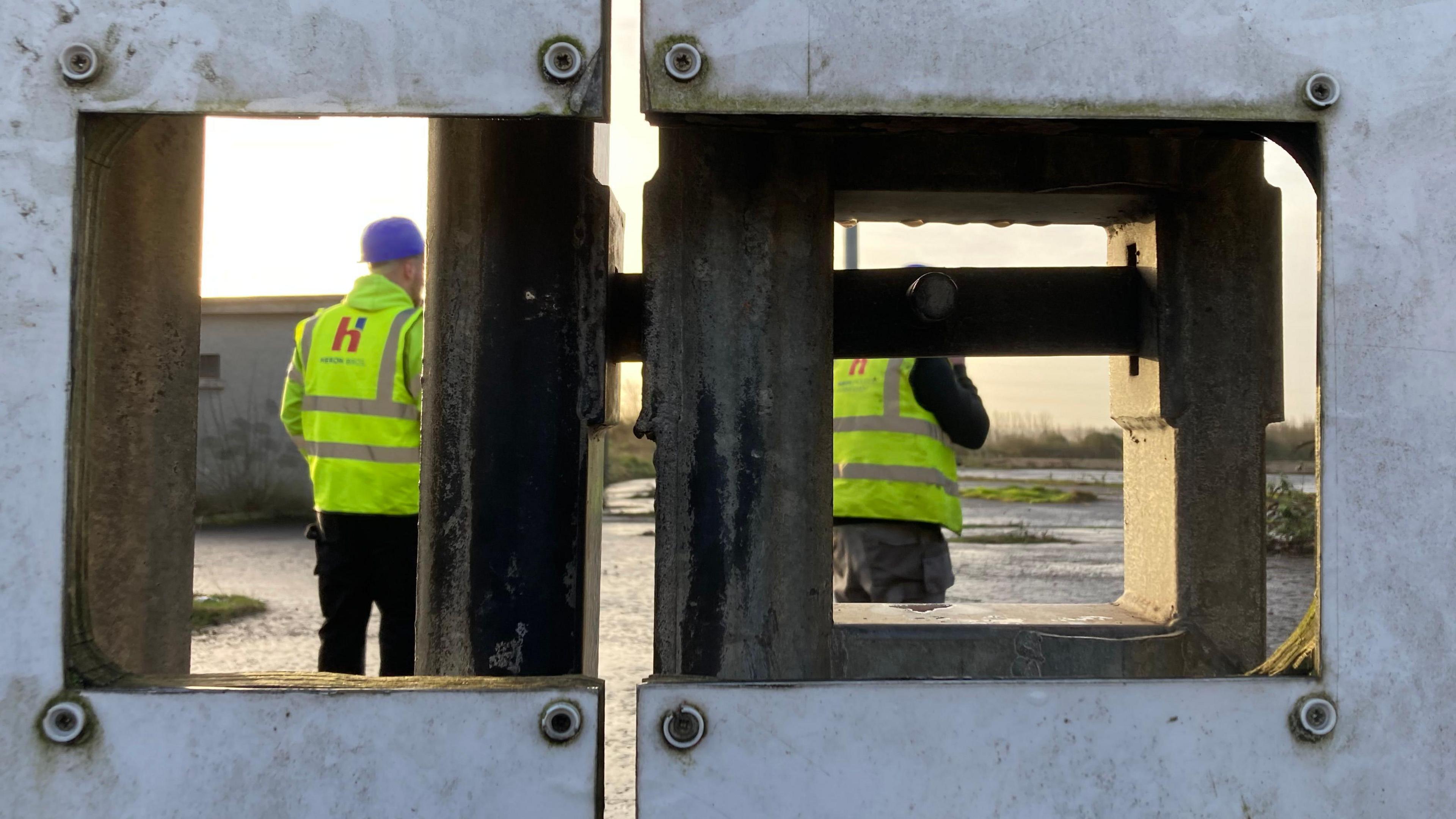 Some workers are on site at Casement. They're wearing hi-vis jackets and hard hats. 