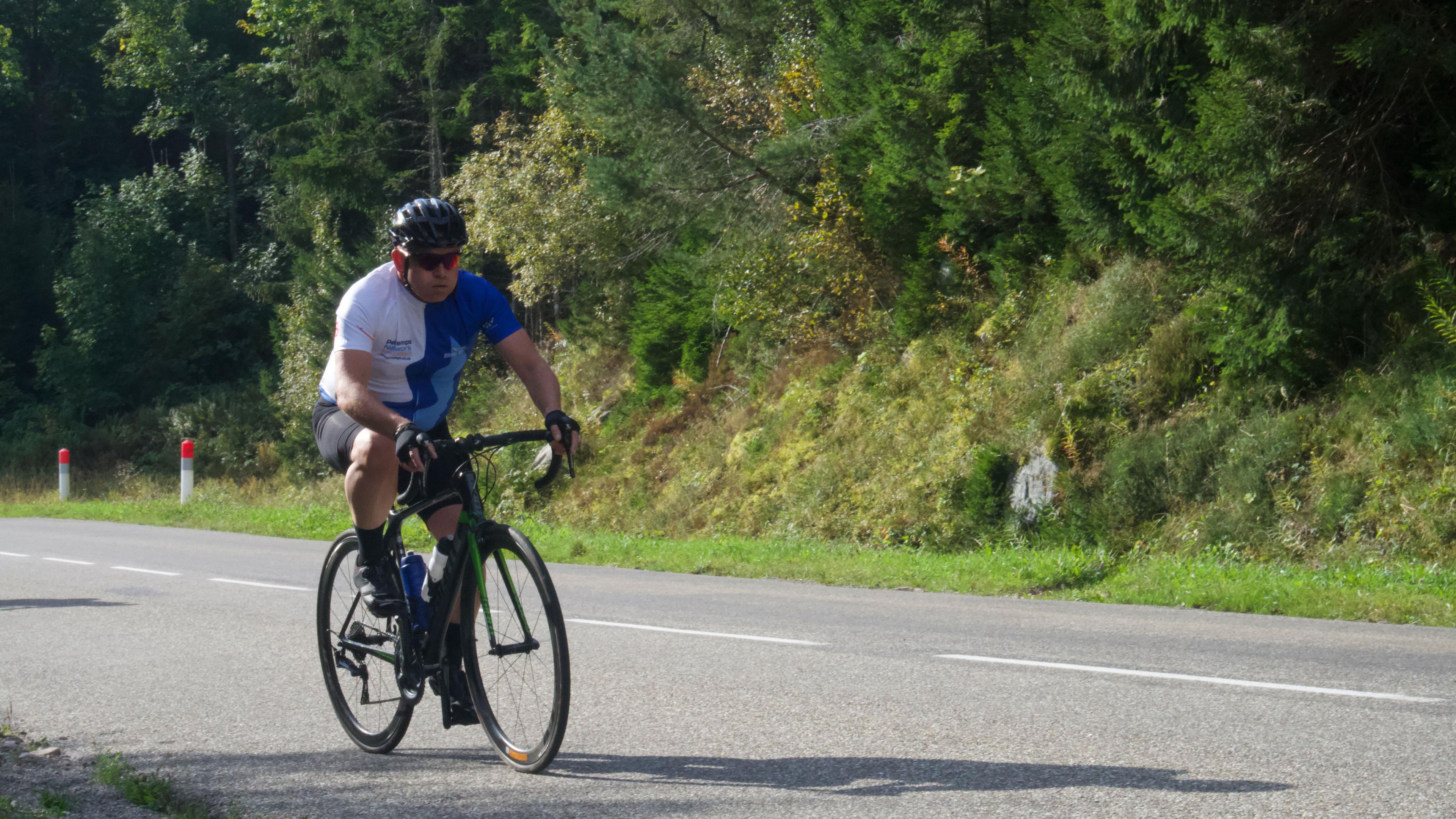 A man riding a bicycle on a road in France