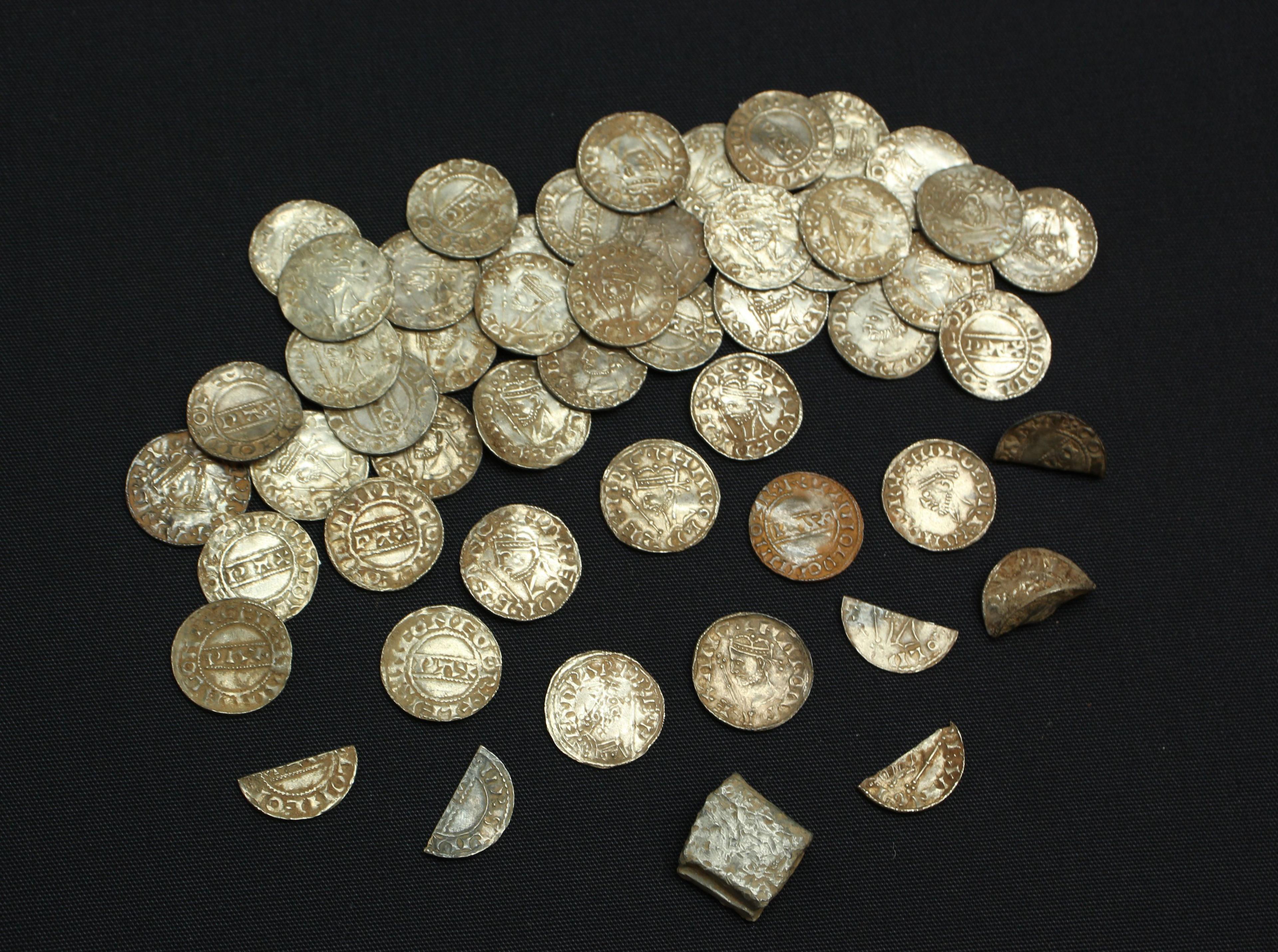 Coins from a Harold II Yorkshire coin hoard, placed on a black cloth