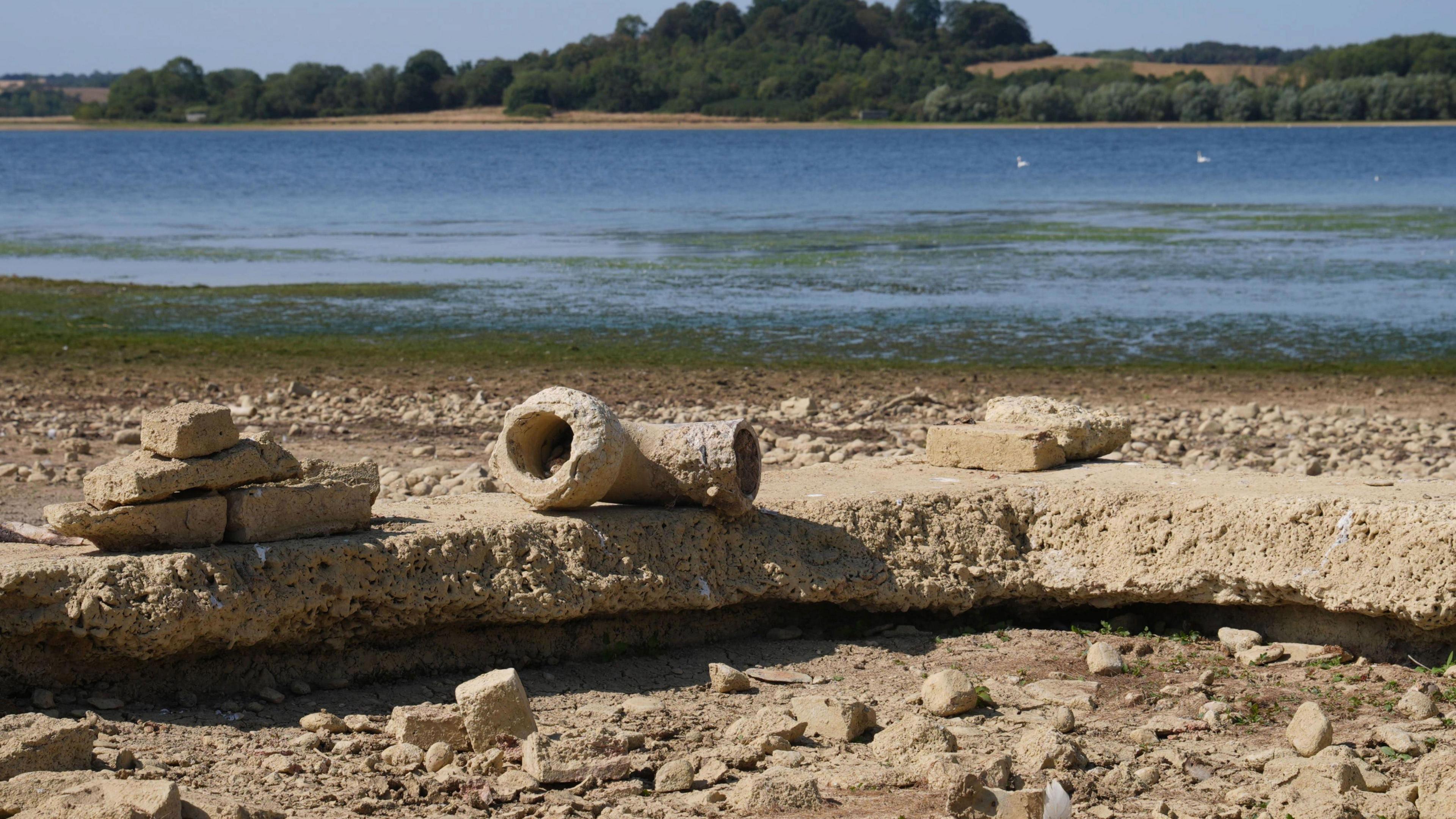 Stonework from the lost village of Nether Hambleton is revealed by the low water levels at Rutland Water reservoir in the East Midlands.