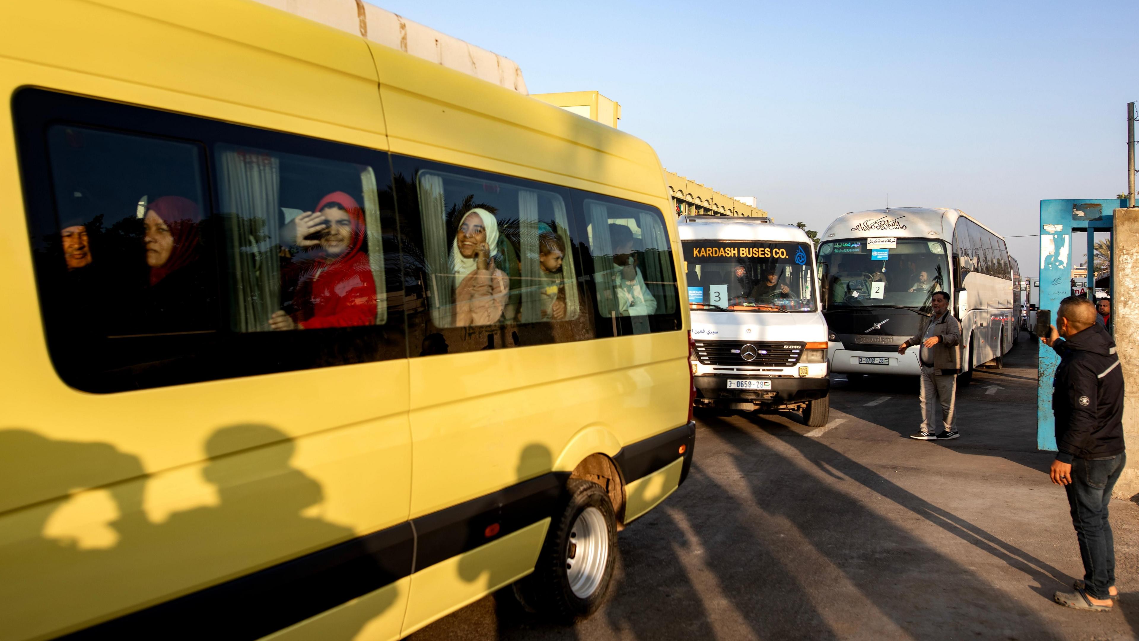 Palestinian patients wave from a bus during an evacuation organised by the World Health Organization (WHO), at the European Hospital in Khan Younis, southern Gaza Strip (6 November 2024)