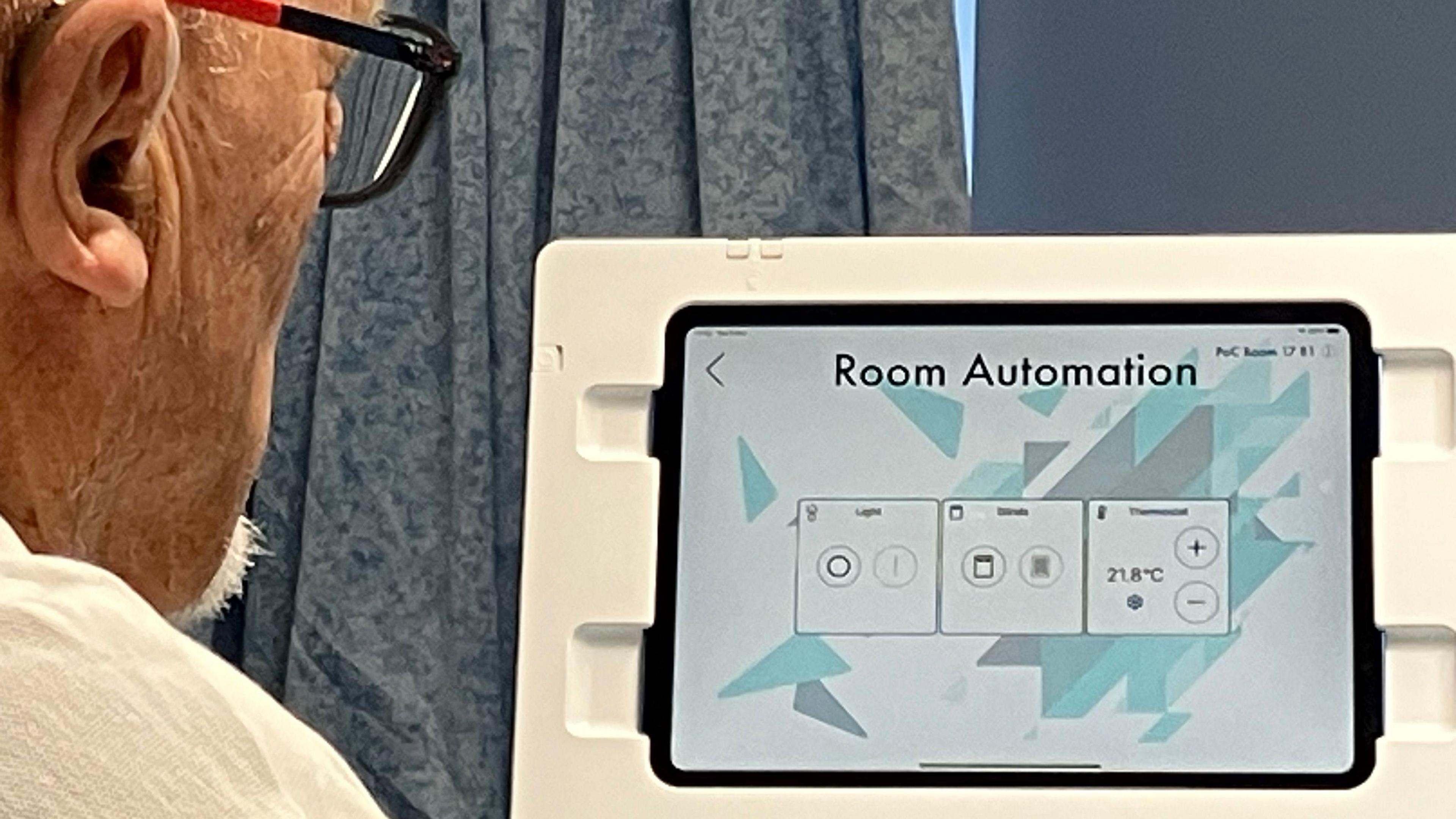 Elderly man looking at a new room automation controls at Nottingham's City Hospital