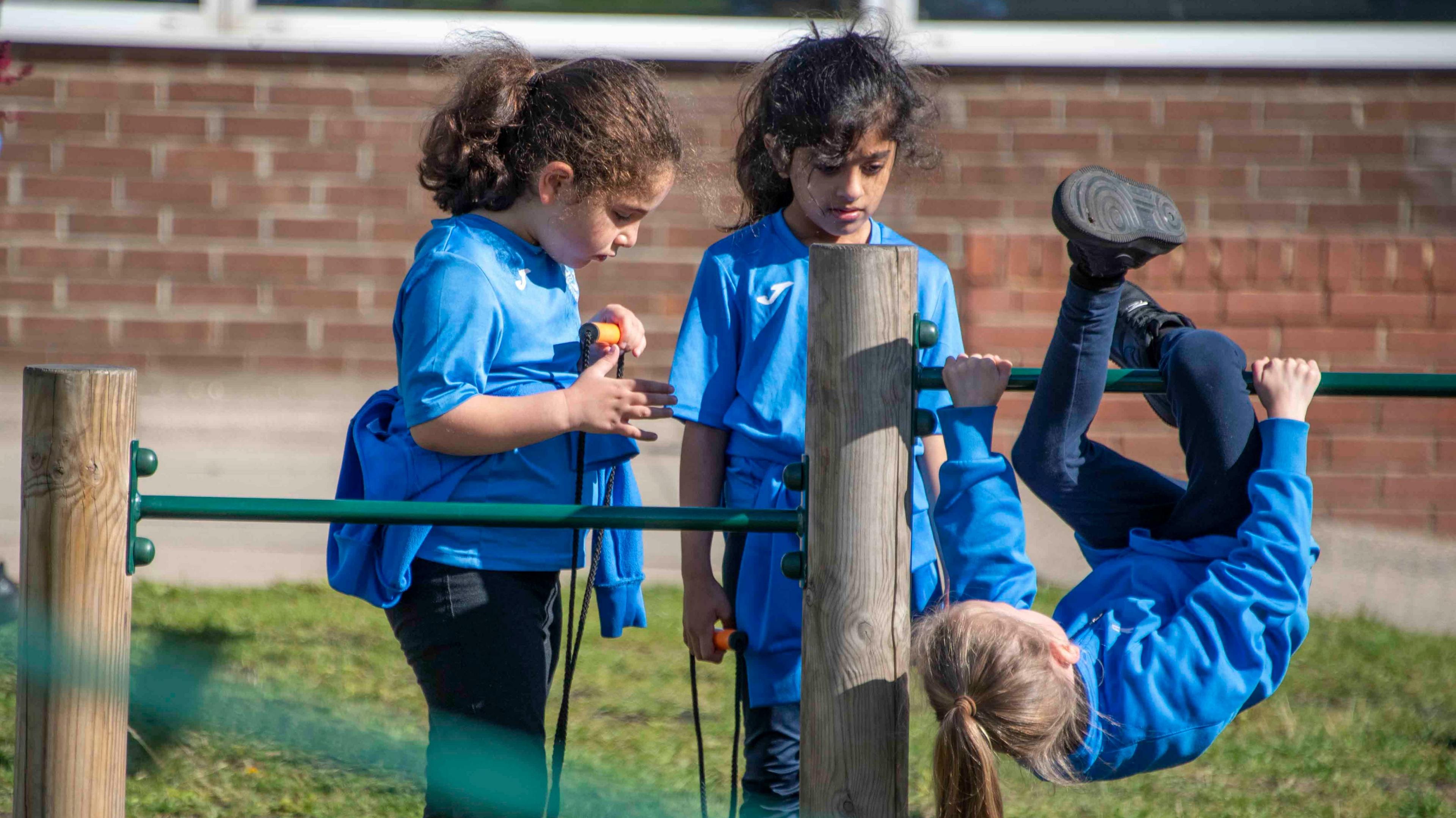 Primary school children playing around in 'active' uniforms 