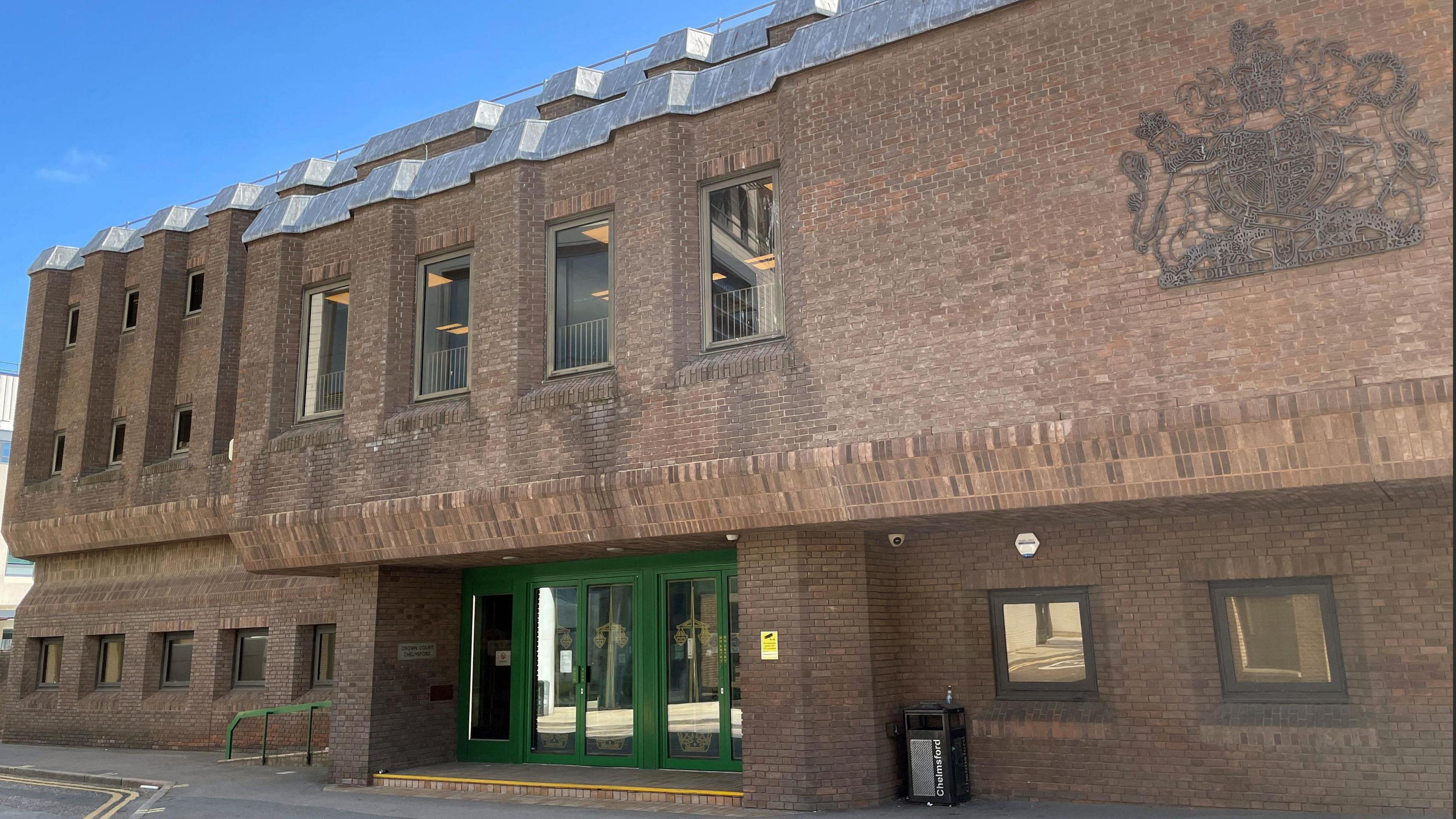 Outside of Chelmsford Crown Court. It is a brown building with a dark green door