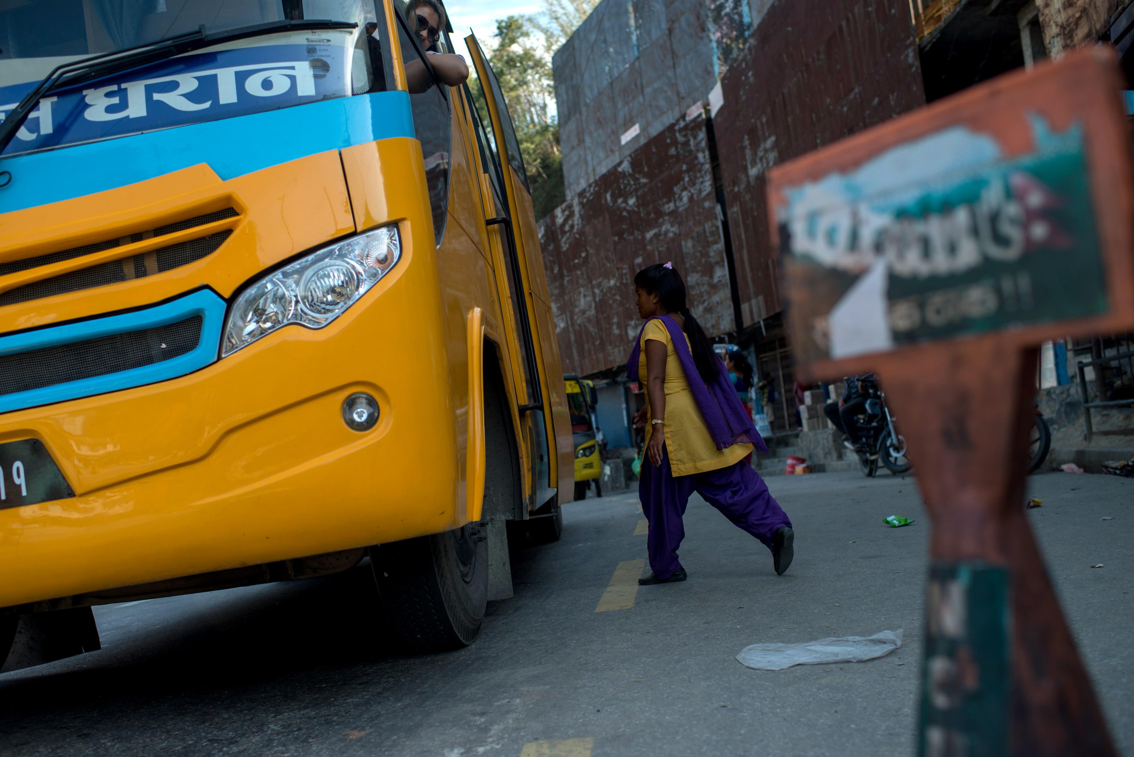 A volunteer prepares to check a bus leaving the Kathmandu valley for possible trafficking victims