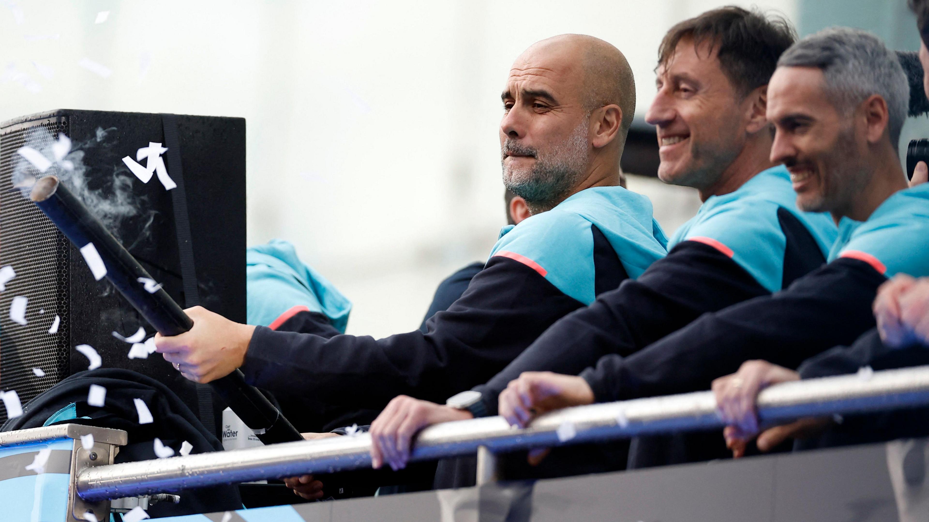 Manchester City manager Pep Guardiola on the bus during the victory parade