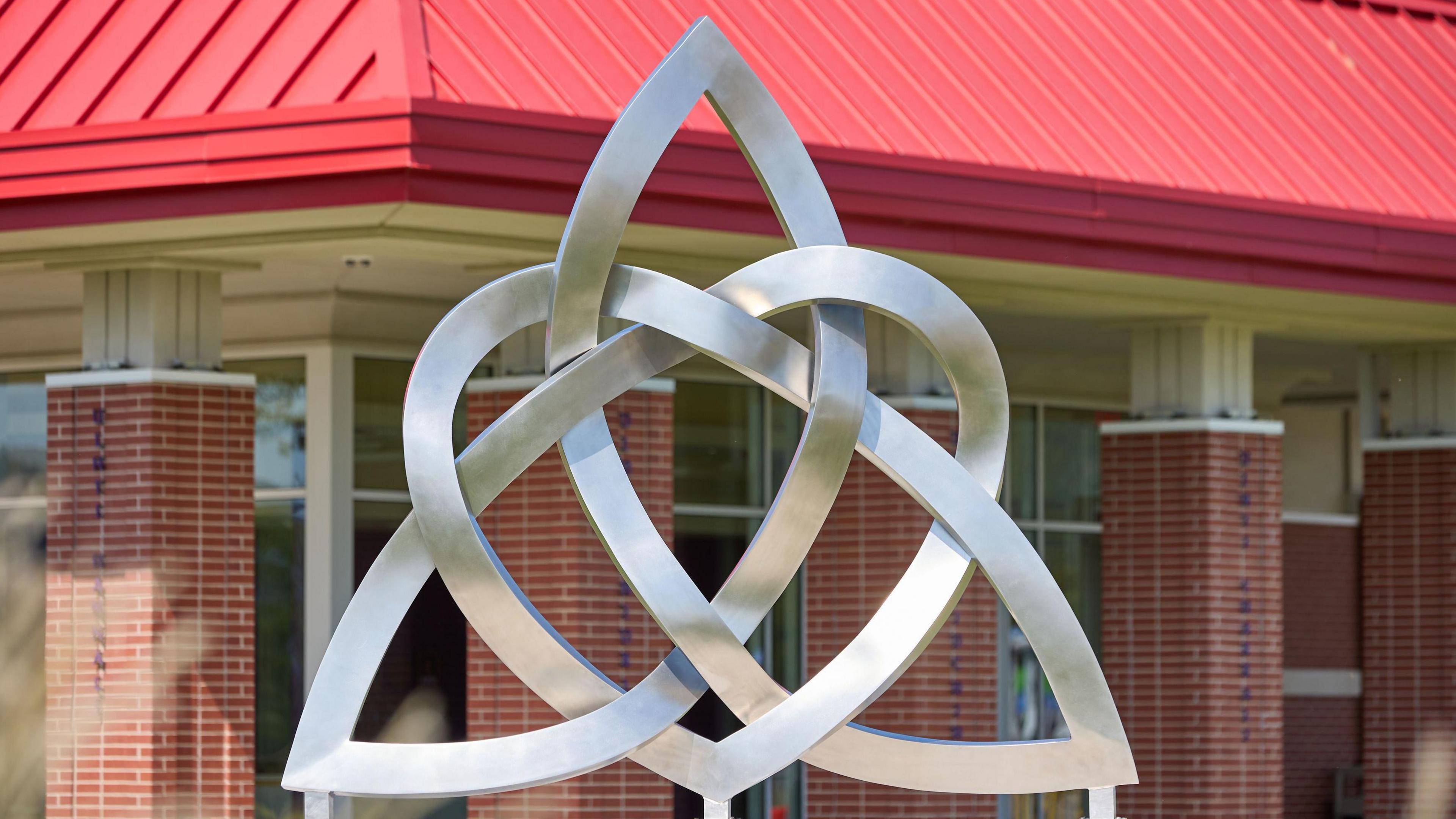 The sculpture combines a Celtic trinity shape intertwined with a heart and is placed facing Ireland.