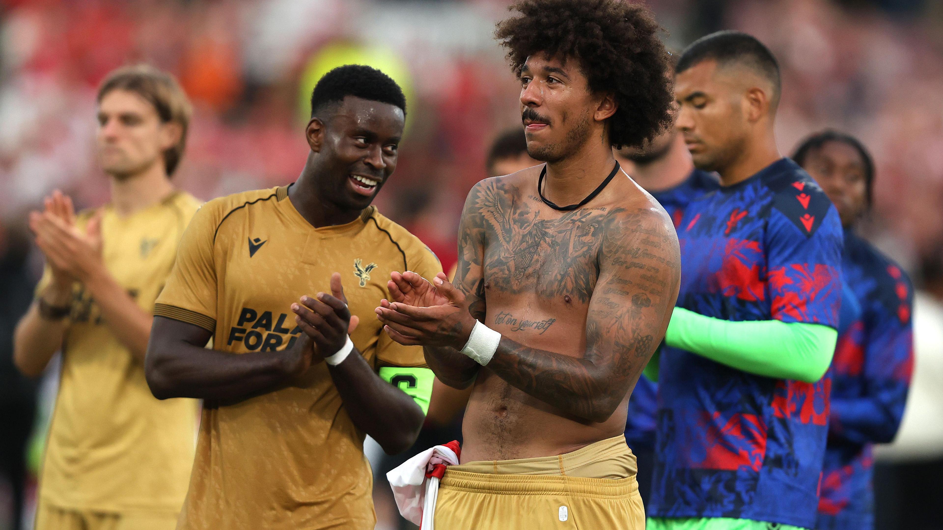 Marc Guehi and Chris Richards applaud the Crystal Palace fans