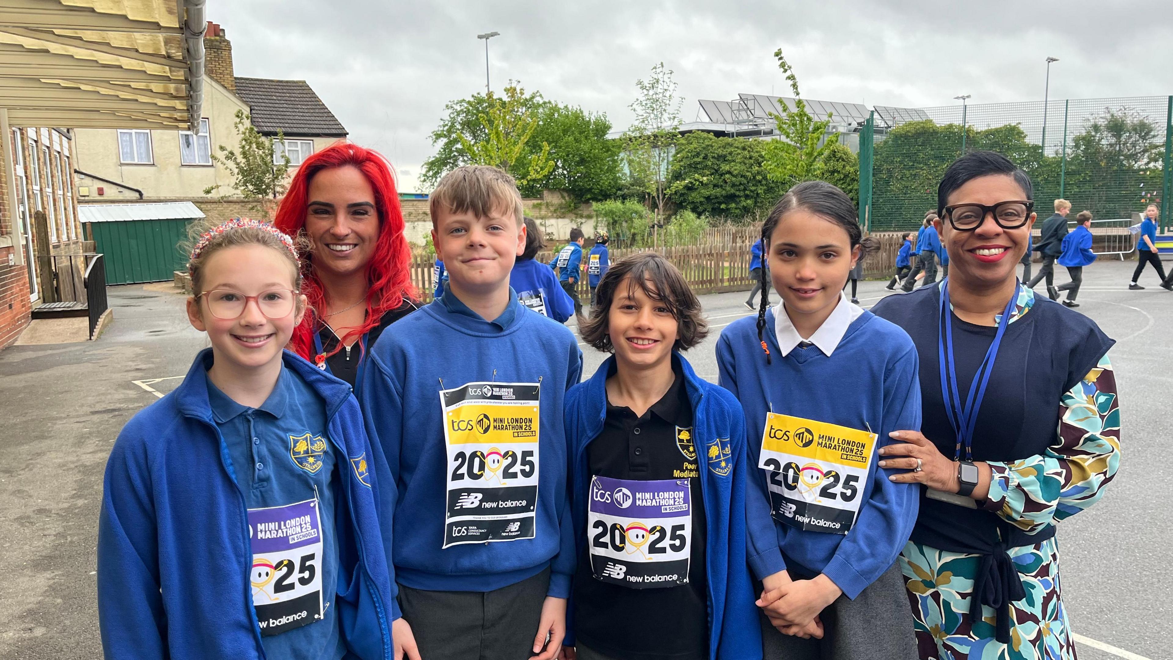Mitzi Nichol, headteacher and Ashleigh Curtis, PE lead, and children from Stillness Junior School in the playground