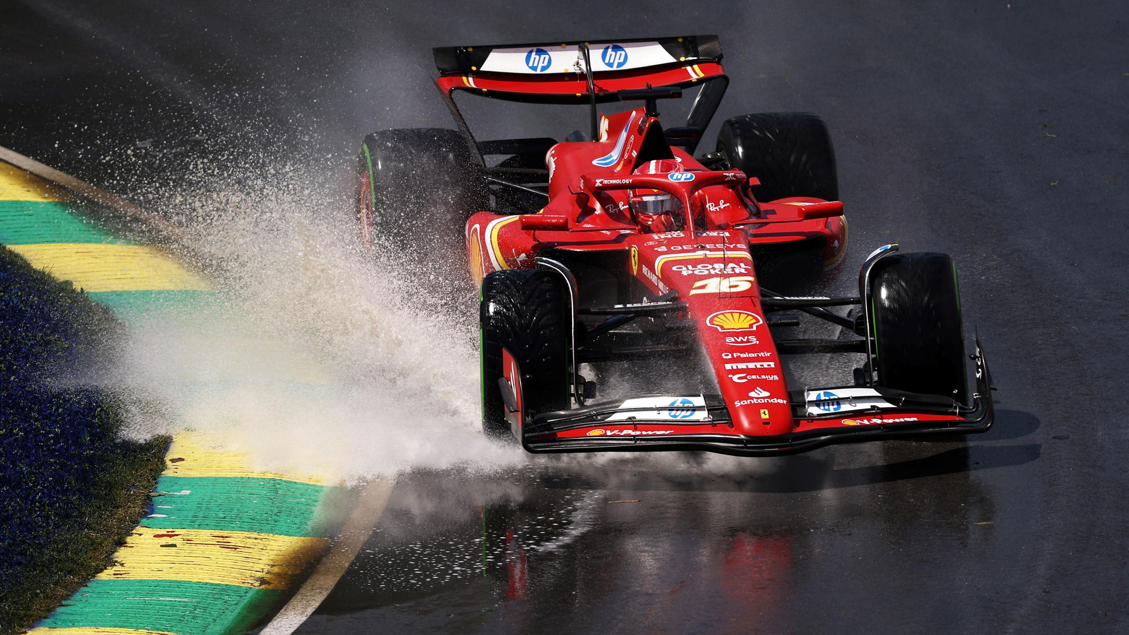 Charles Leclerc's Ferrari throws up spray from standing water on the Circuit Gilles Villeneuve track