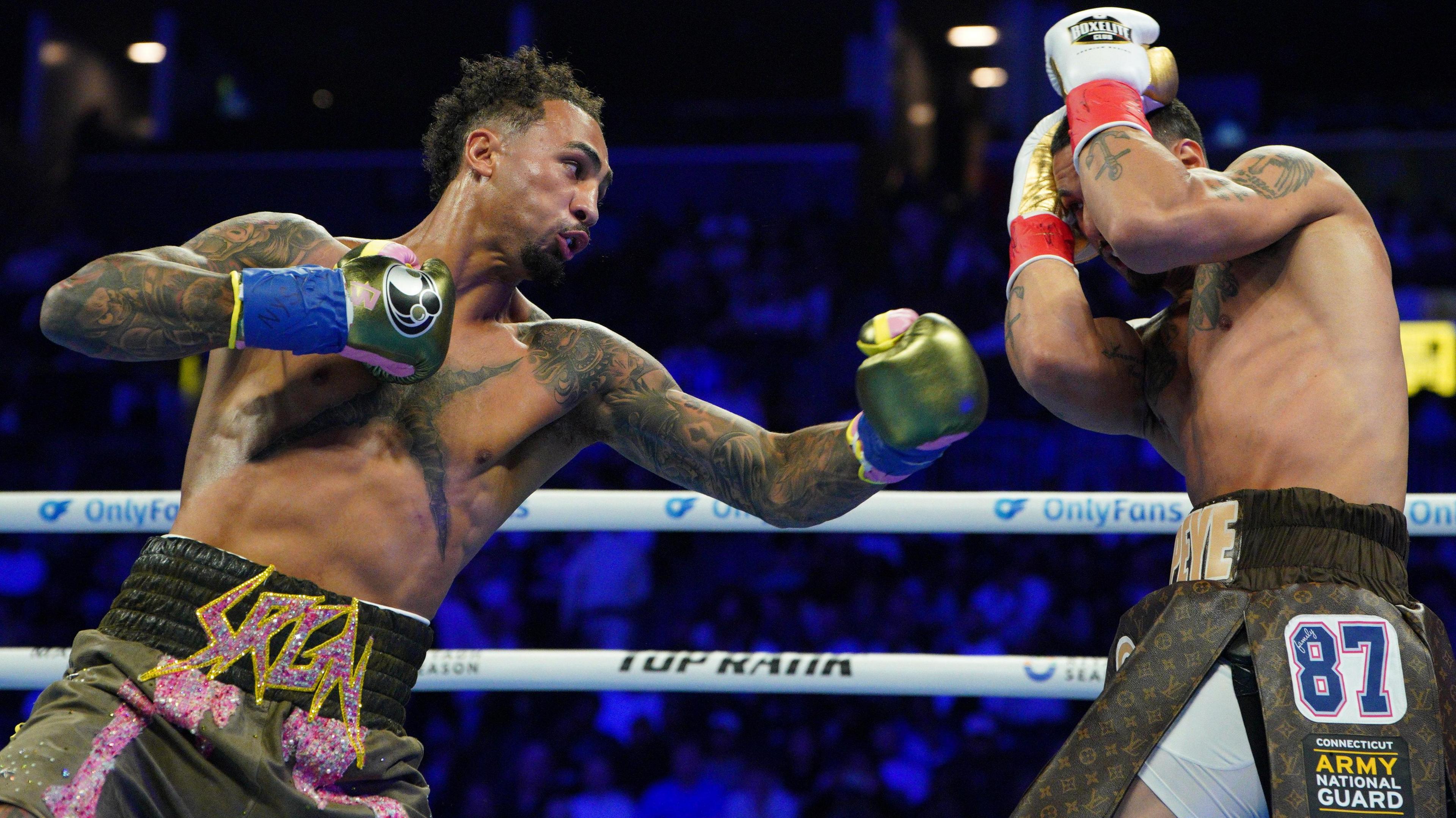 Great Britain's Ben Whittaker punches Richard Rivera during their light-heavyweight bout in Brooklyn