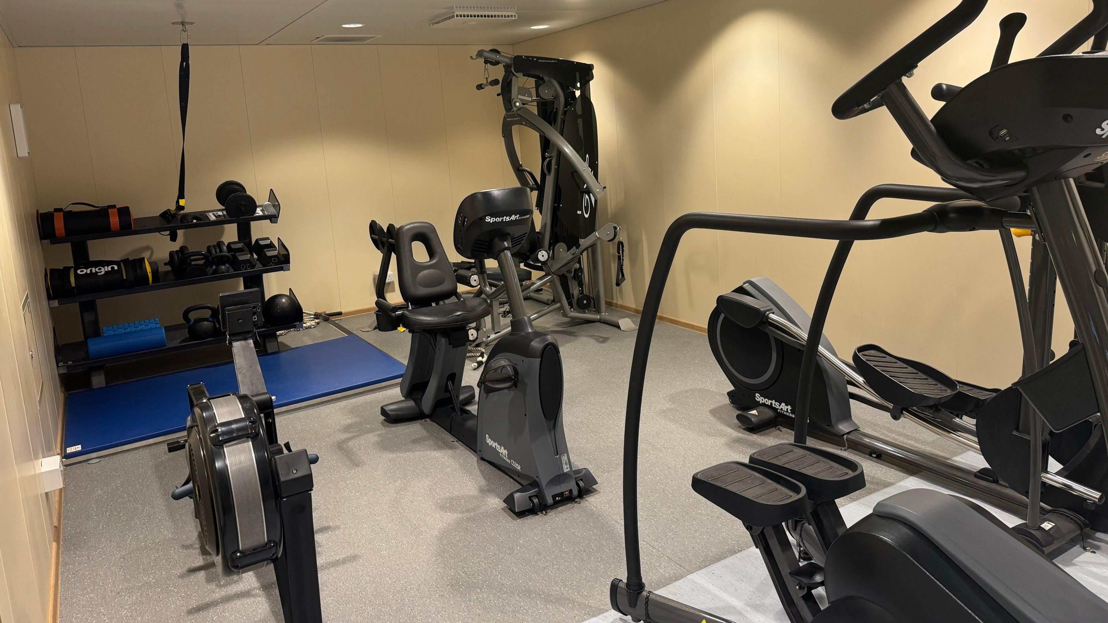 A gym which a selection of weights and cardiovascular machines.