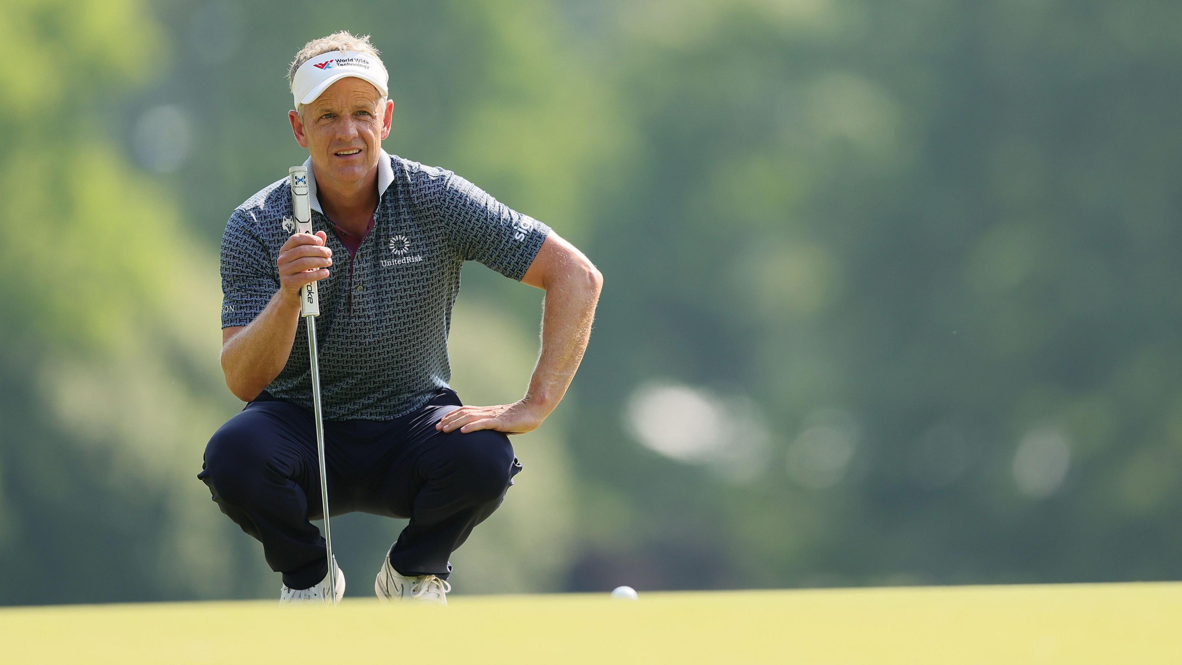 Luke Donald reads a putt