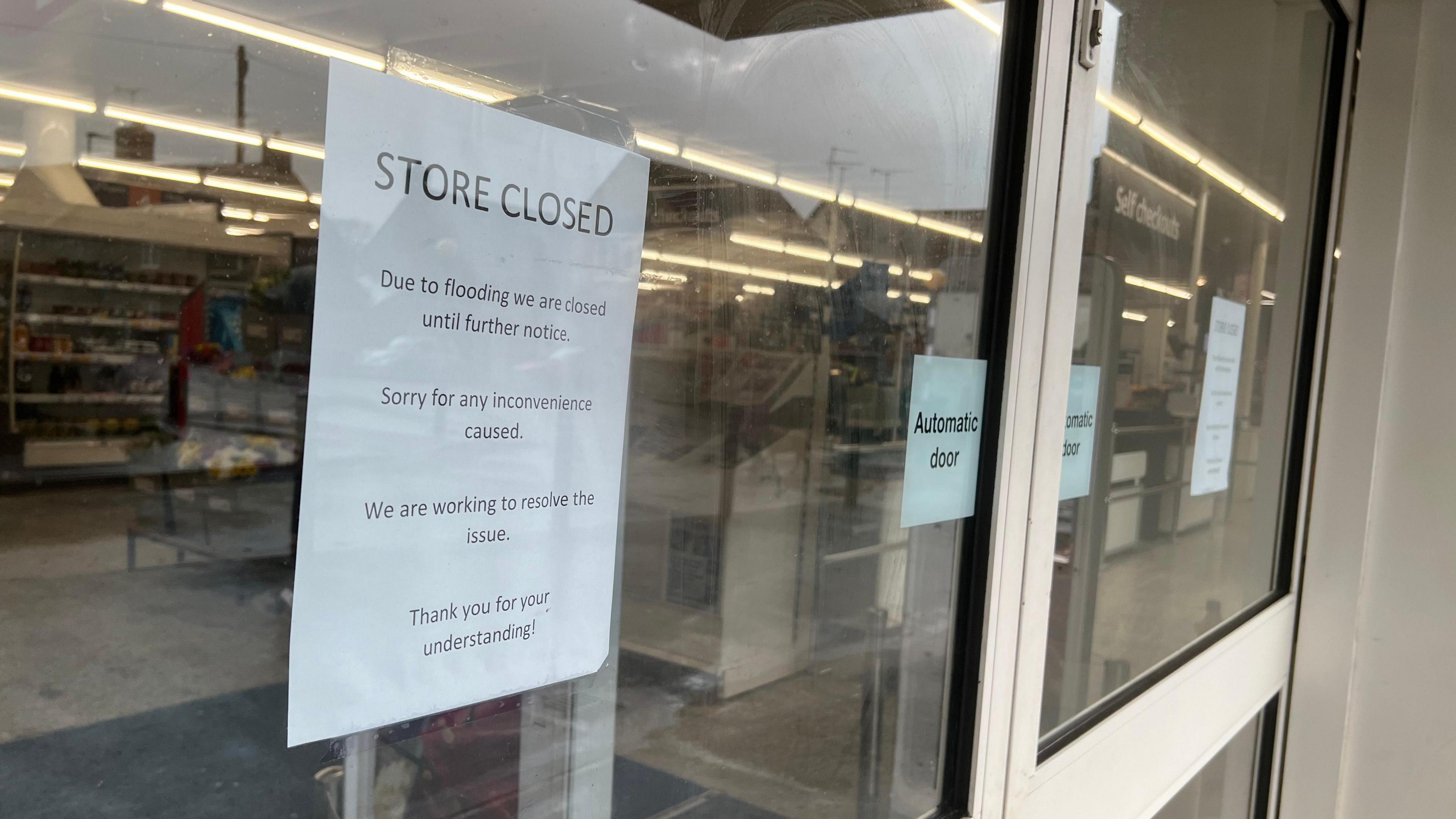 Store closed sign on a window.