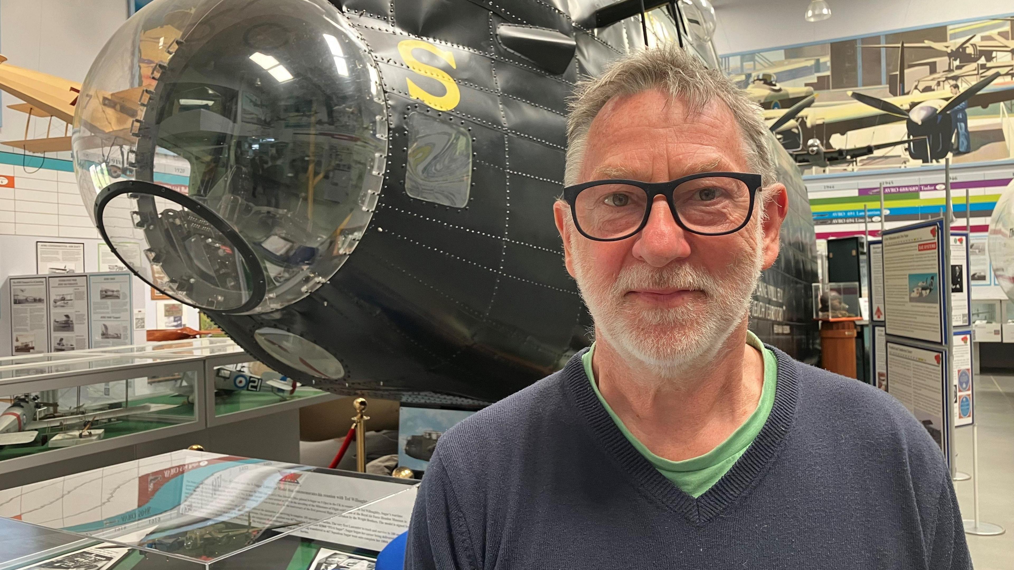 Photograph of the local war historian Frank Pleszak at the Avro Heritage Museum in Stockport. He's pictured in front of the cockpit of a Lancaster bomber.