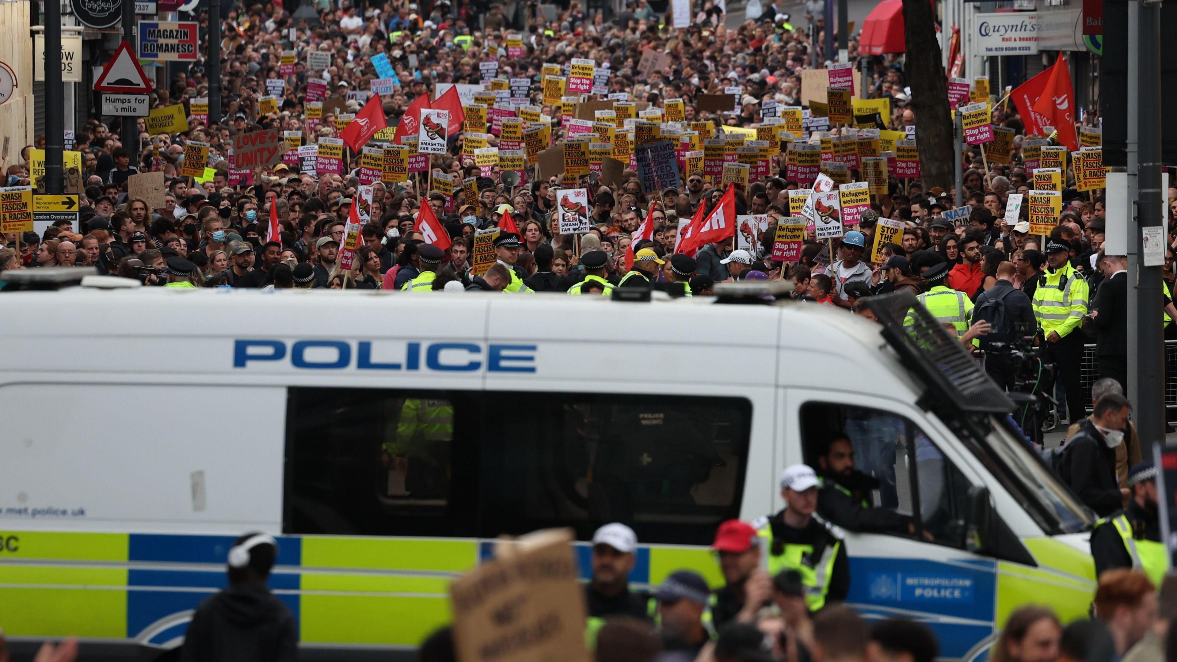 Police van in front of anti-racism protesters in Walthamstow