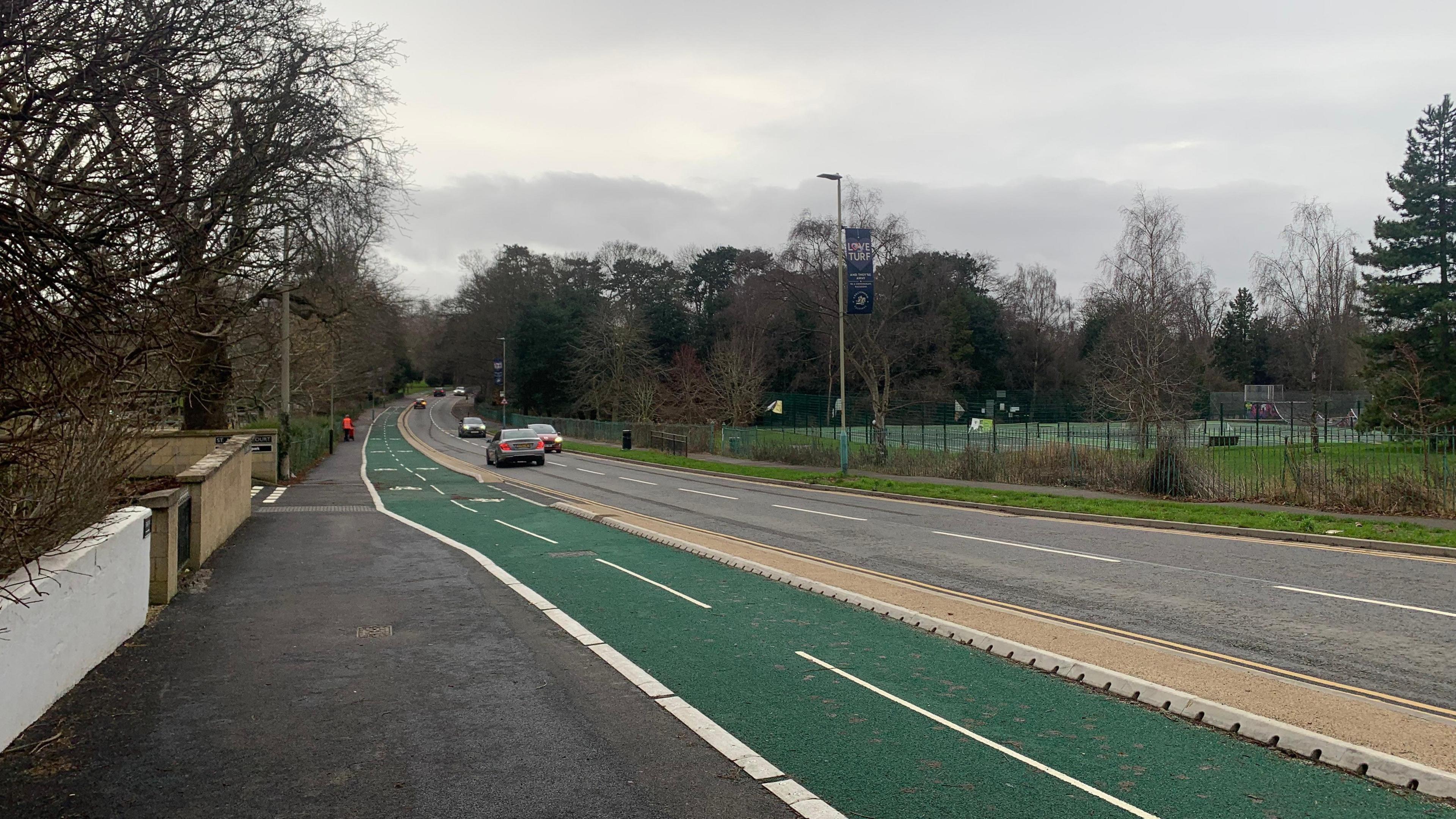 A green two-lane cycle path next to the carriageway on Evesham Road