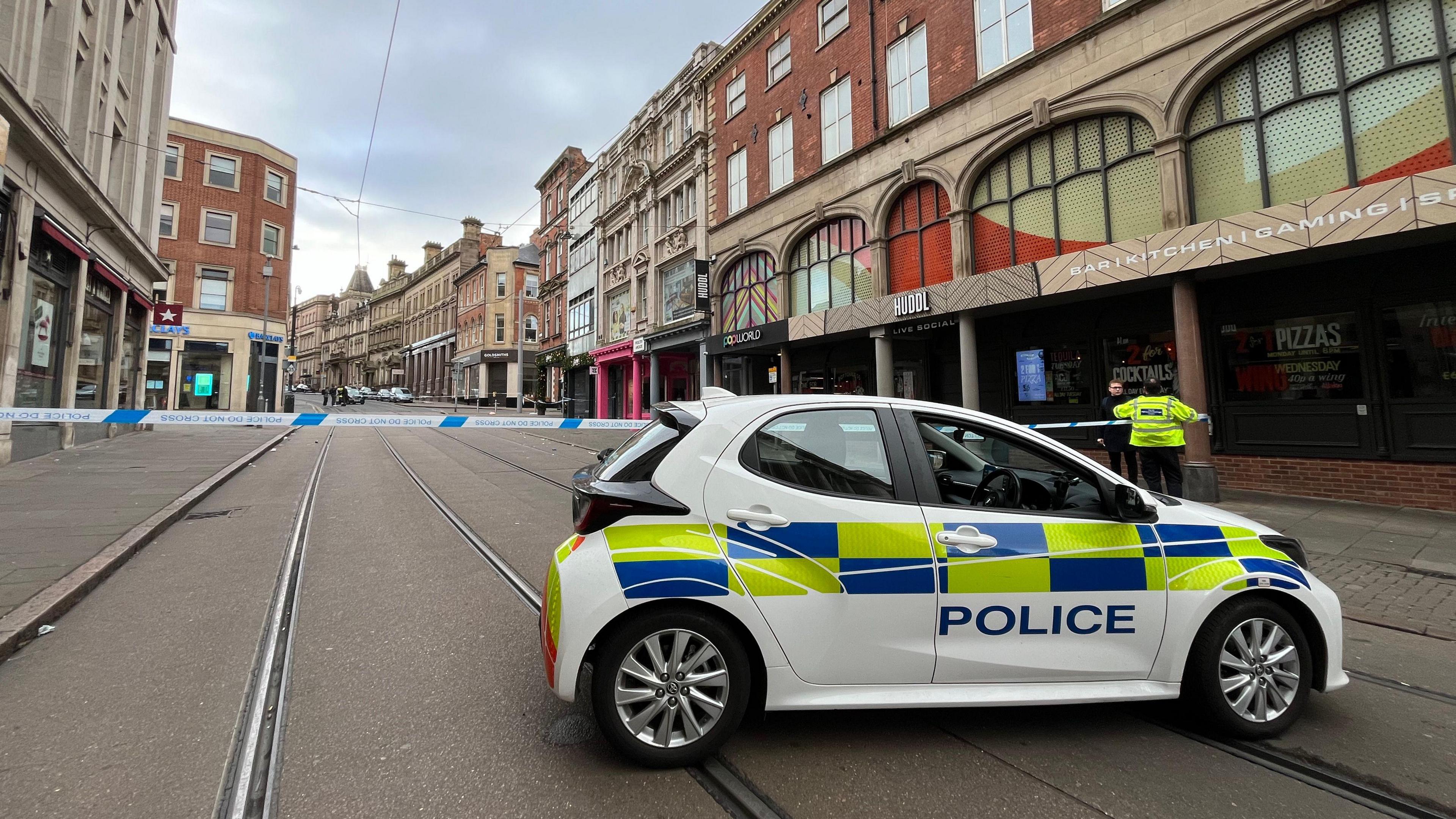 The cordon in place along the tram tracks with a police car blocking the route