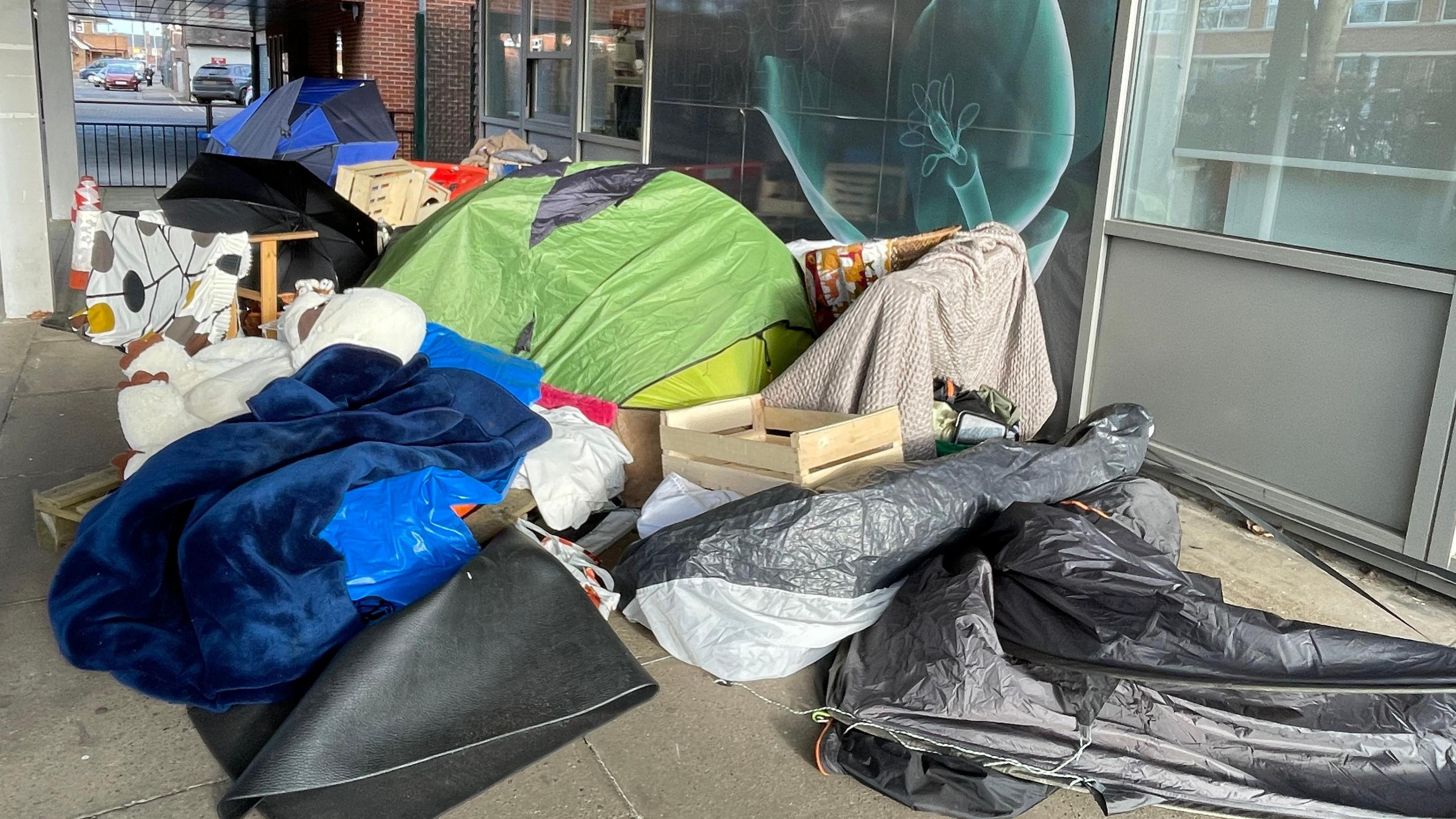 Pile of blankets, tents, plastic sheeting and mats