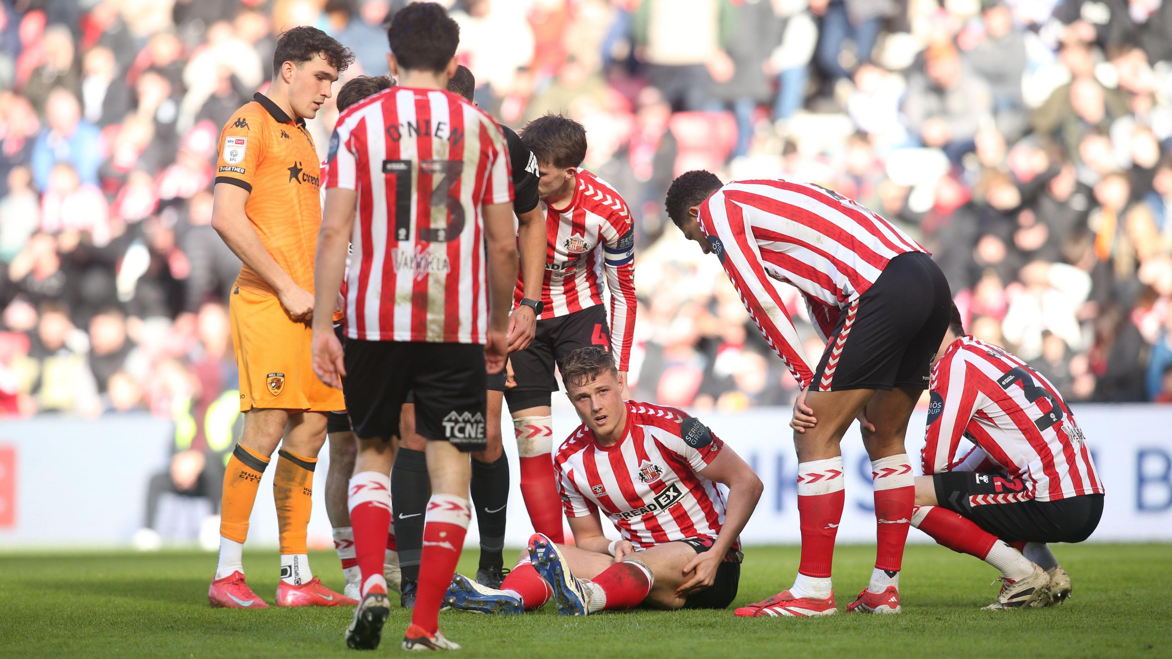 Sunderland's Dan Ballard sits on the turf after suffering an injury against Hull City