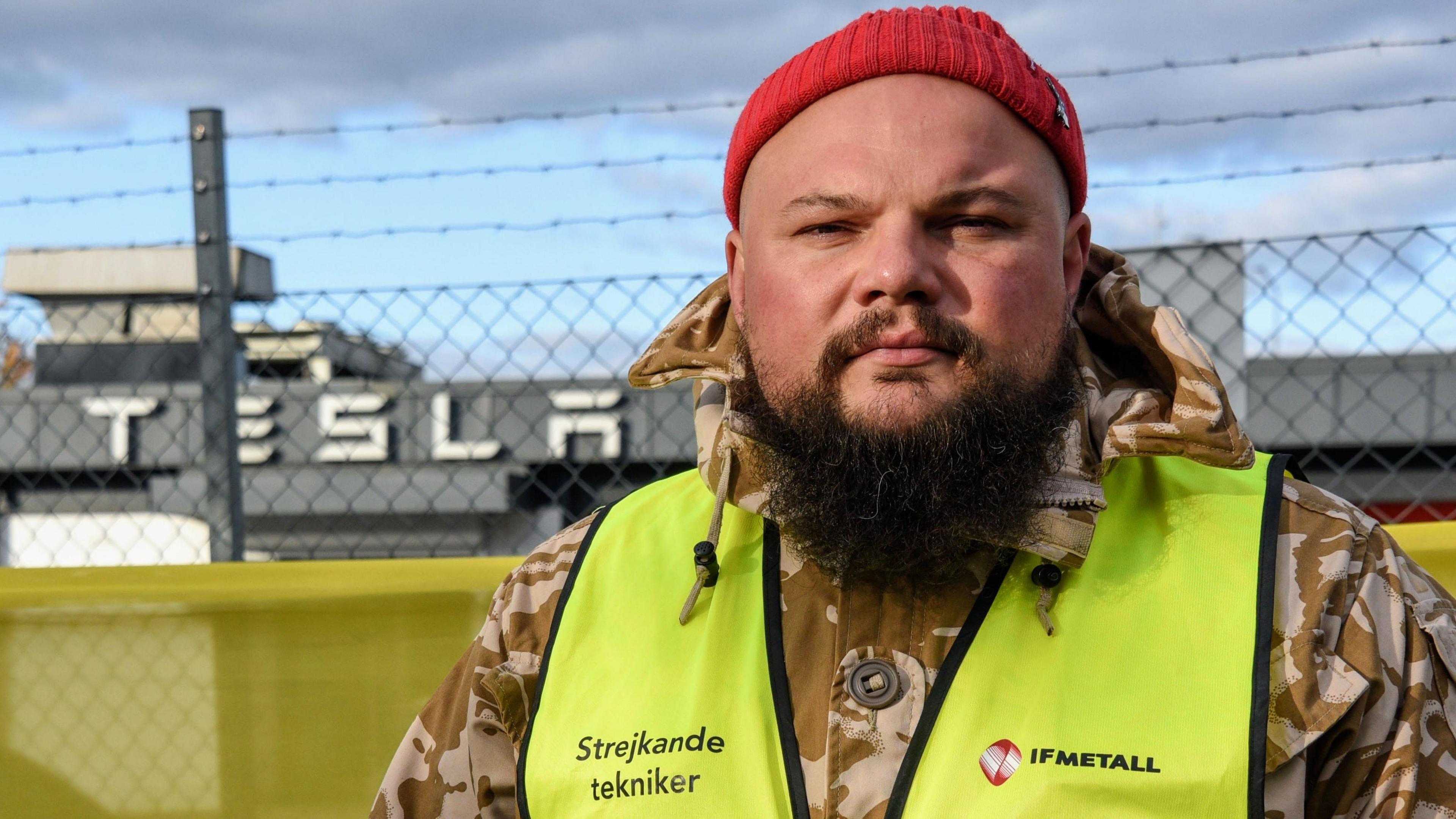 Striking Tesla mechanic Janis Kuzma standing on the picket line outside a Tesla garage in Malmö