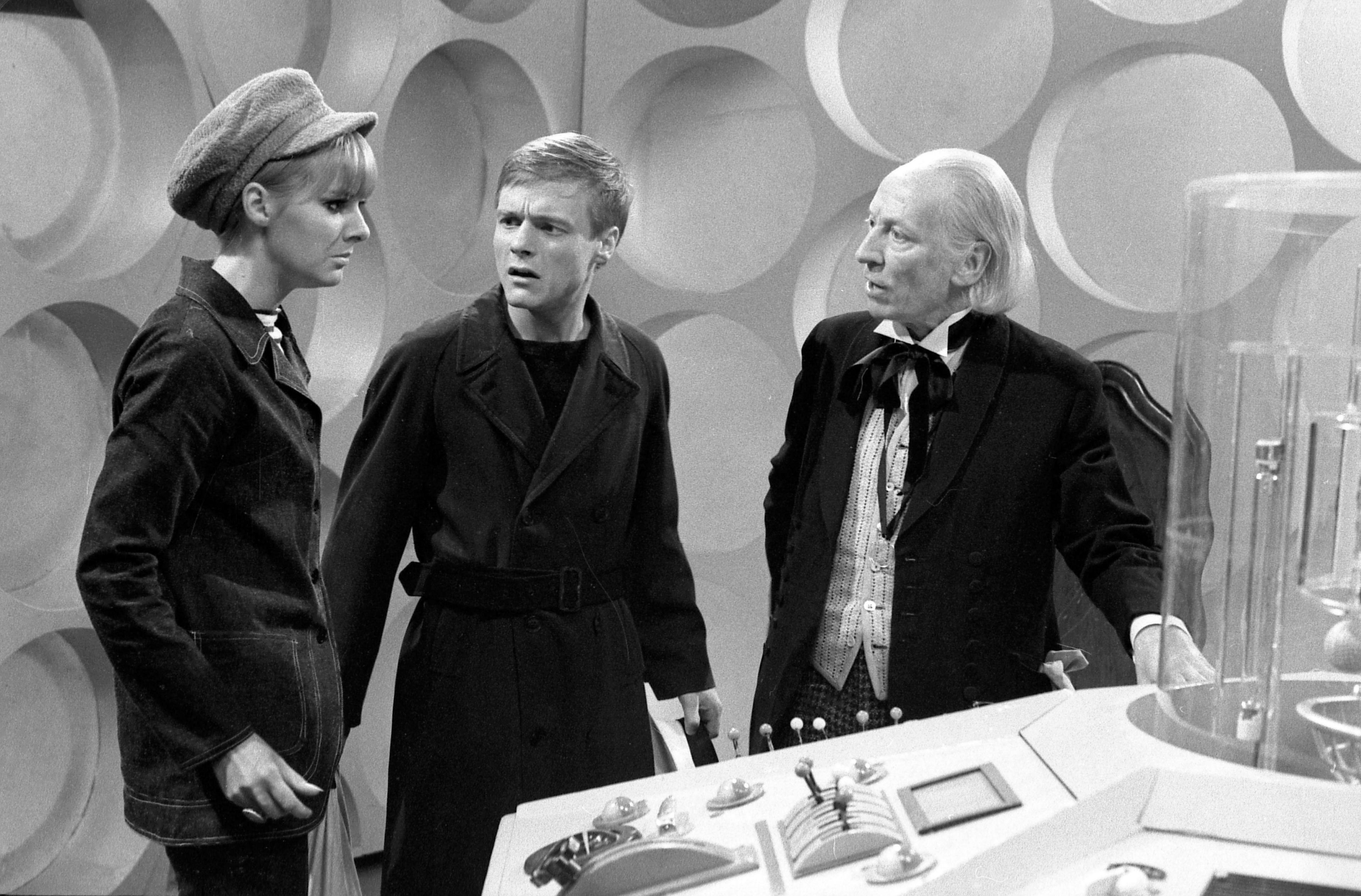 Black and White photo of Anneke Wills, Michael Craze and William Hartnell standing by the console inside the TARDIS