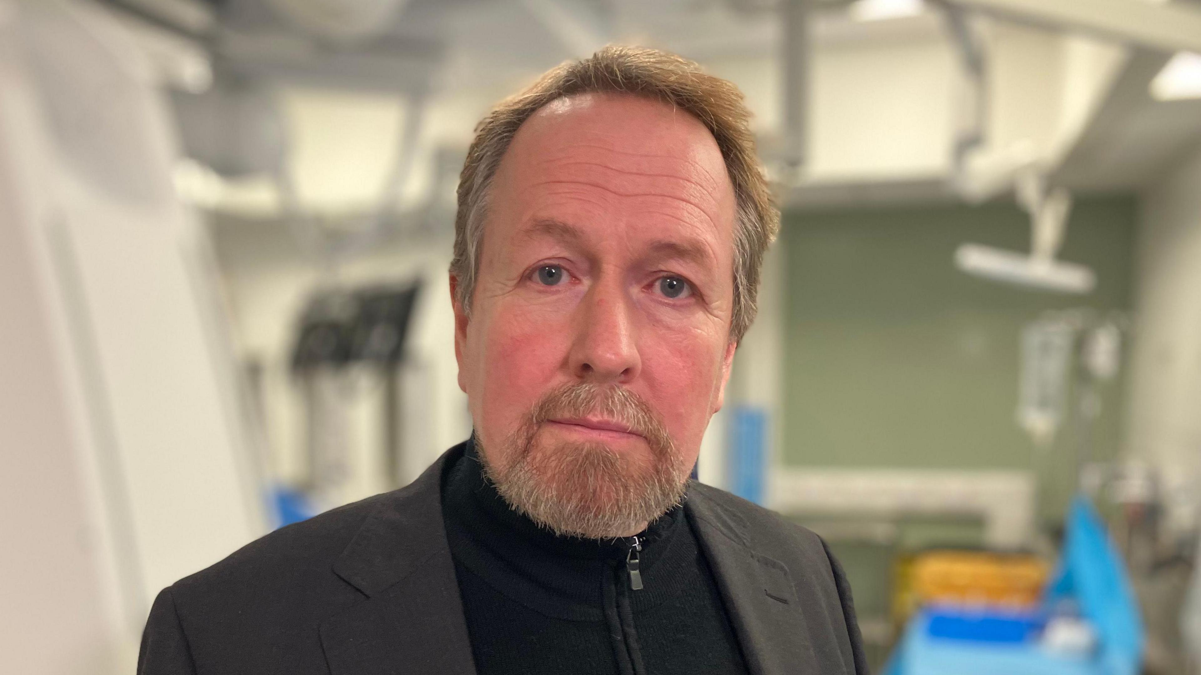 Kevin looks into the camera while visiting the new Interventional Radiology theatres at the Queen's Medical Centre in Nottingham