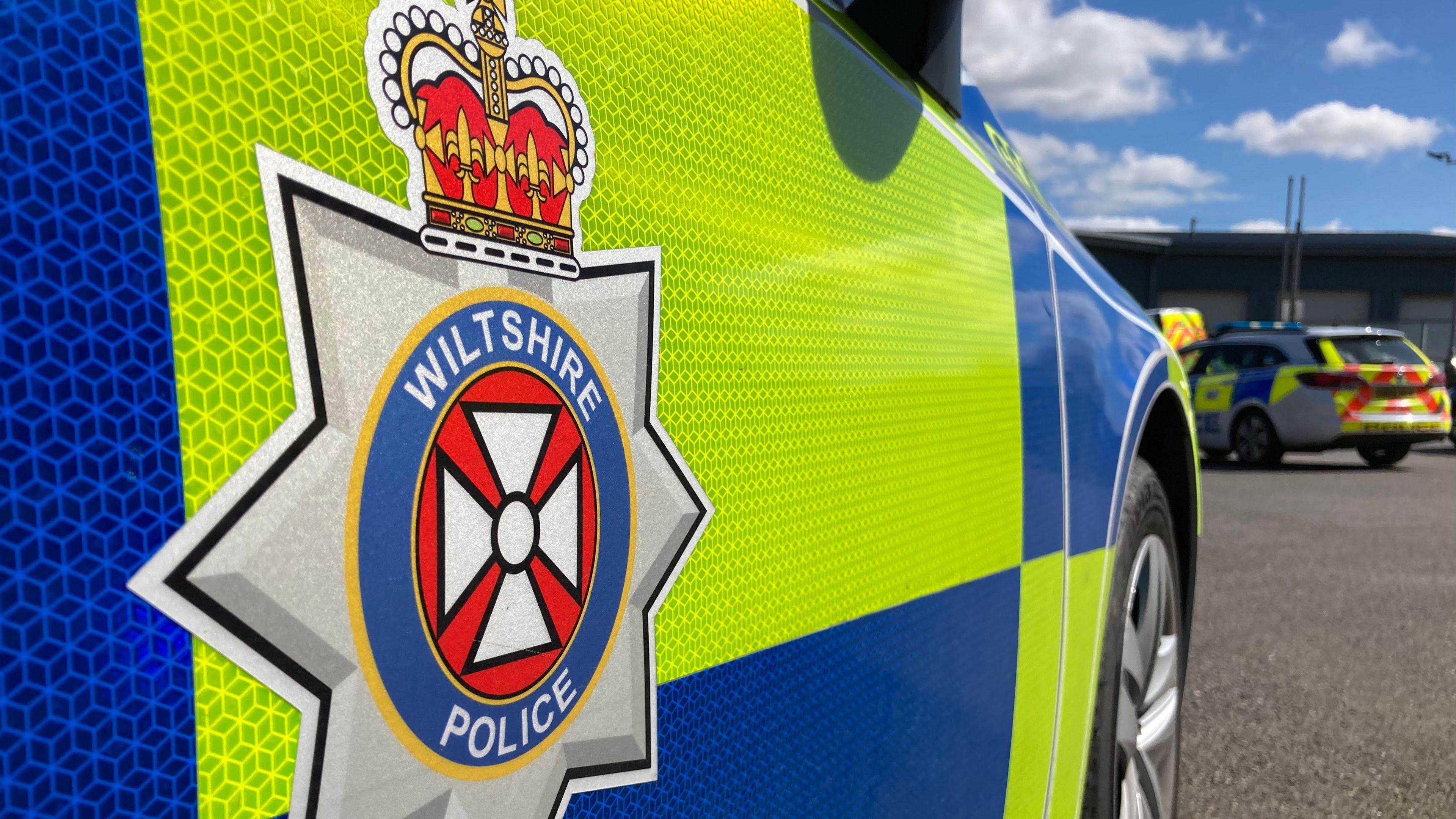 The generic side of a Wiltshire Police car, close-up showing the force logo