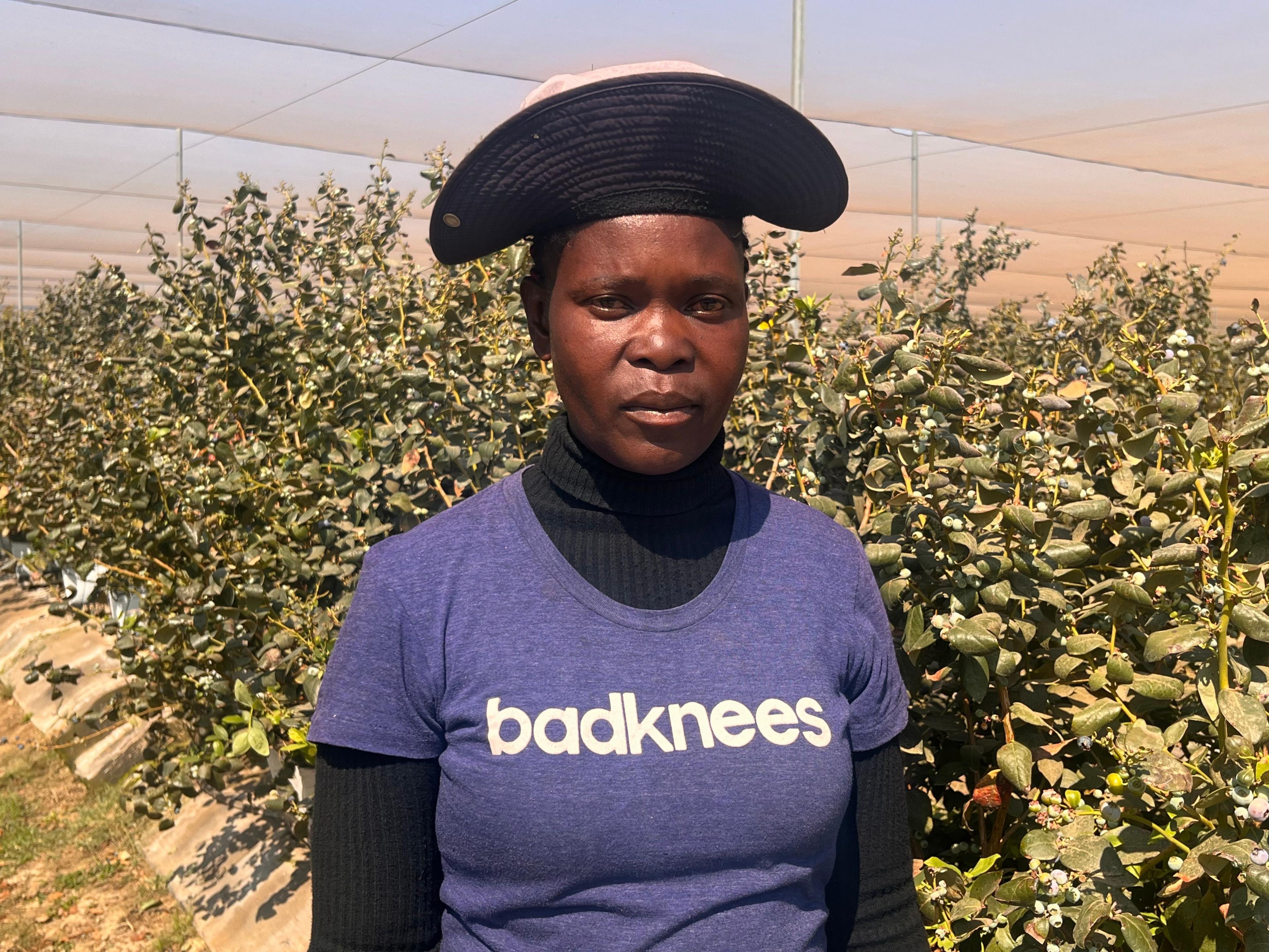 Rebecca Bonzo, wearing a cap and a blue top