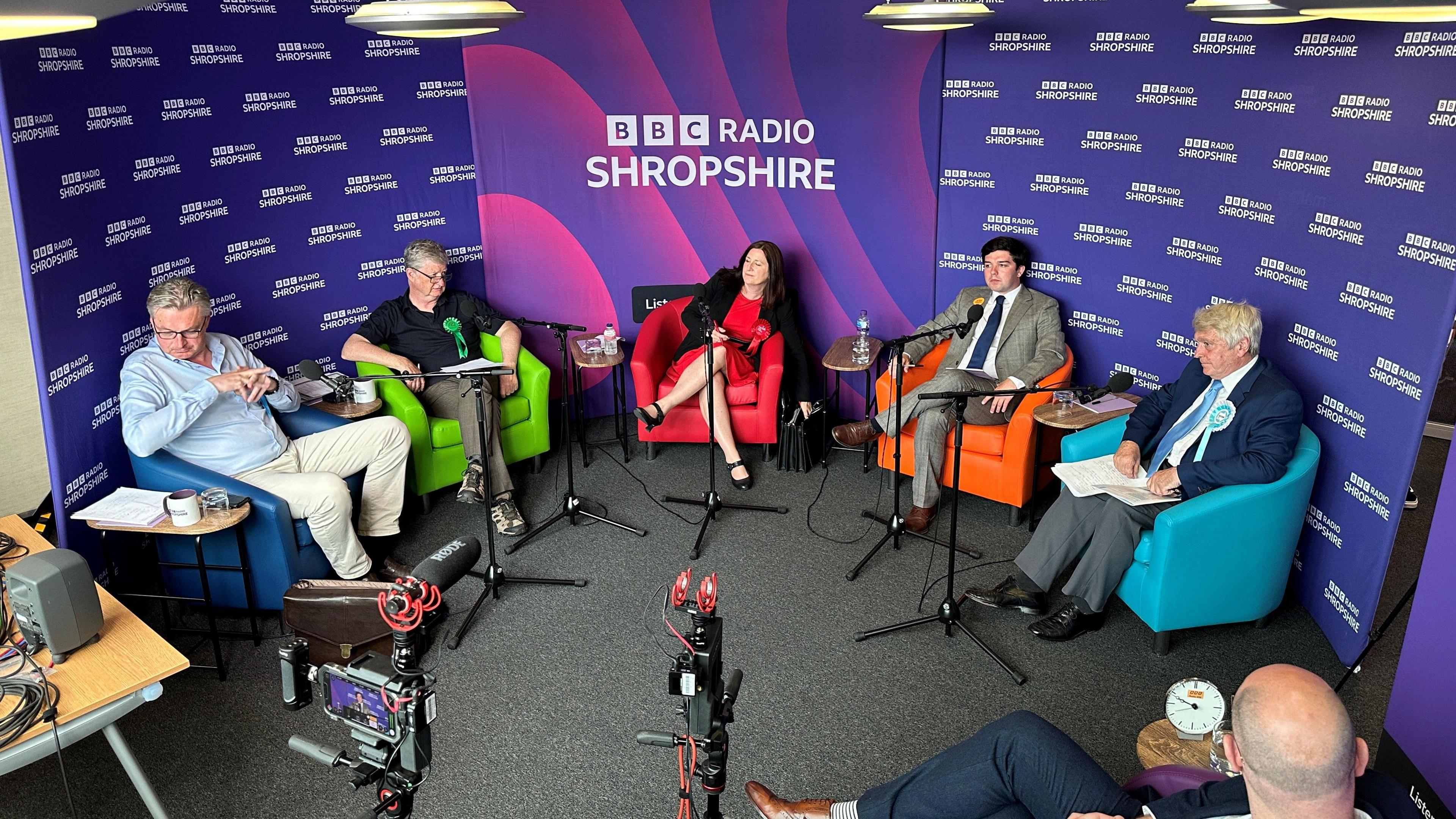 The five Shrewsbury election candidates sitting in chairs in front of cameras and a presenter