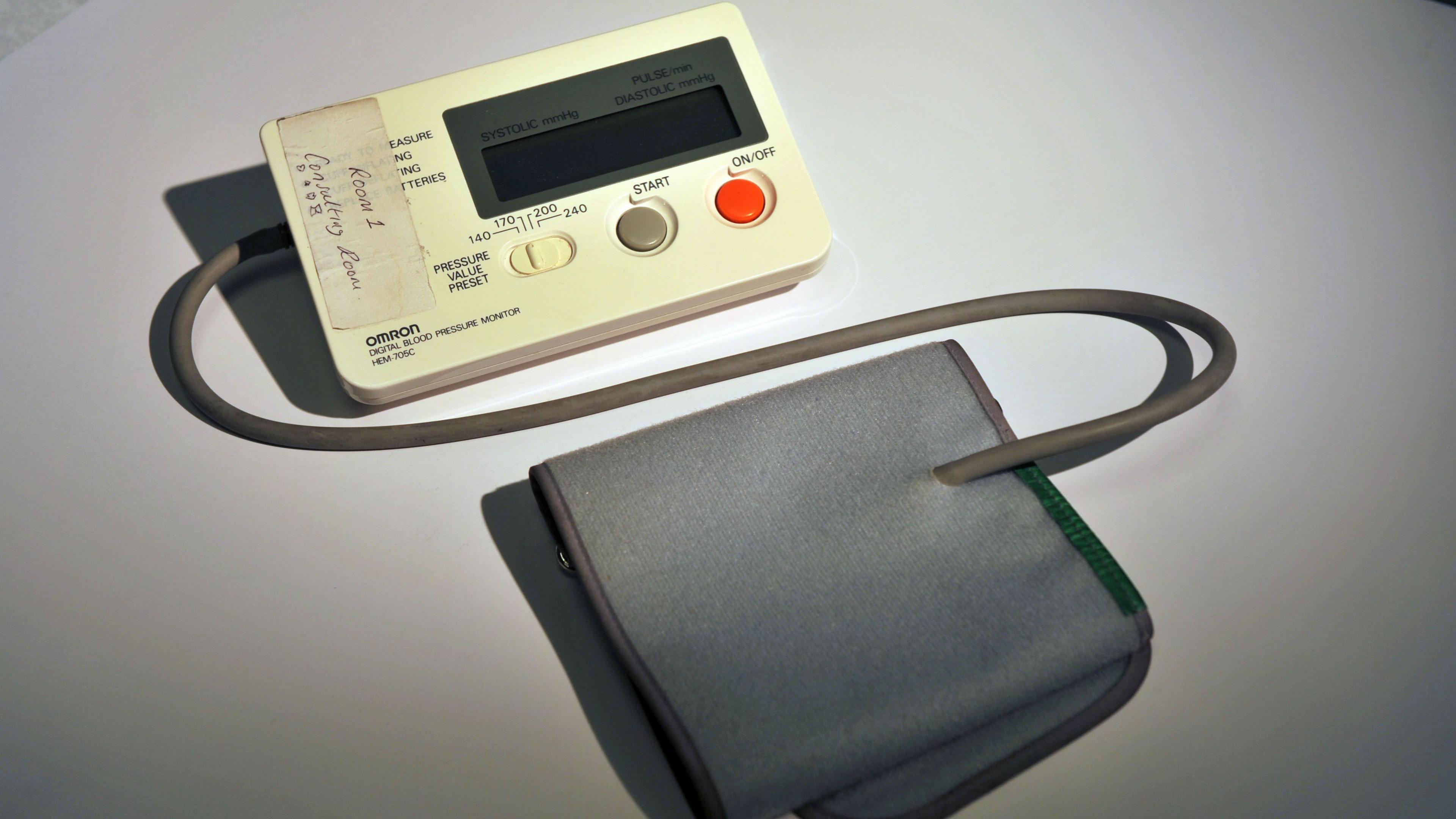 A blood pressure monitor on a white table.