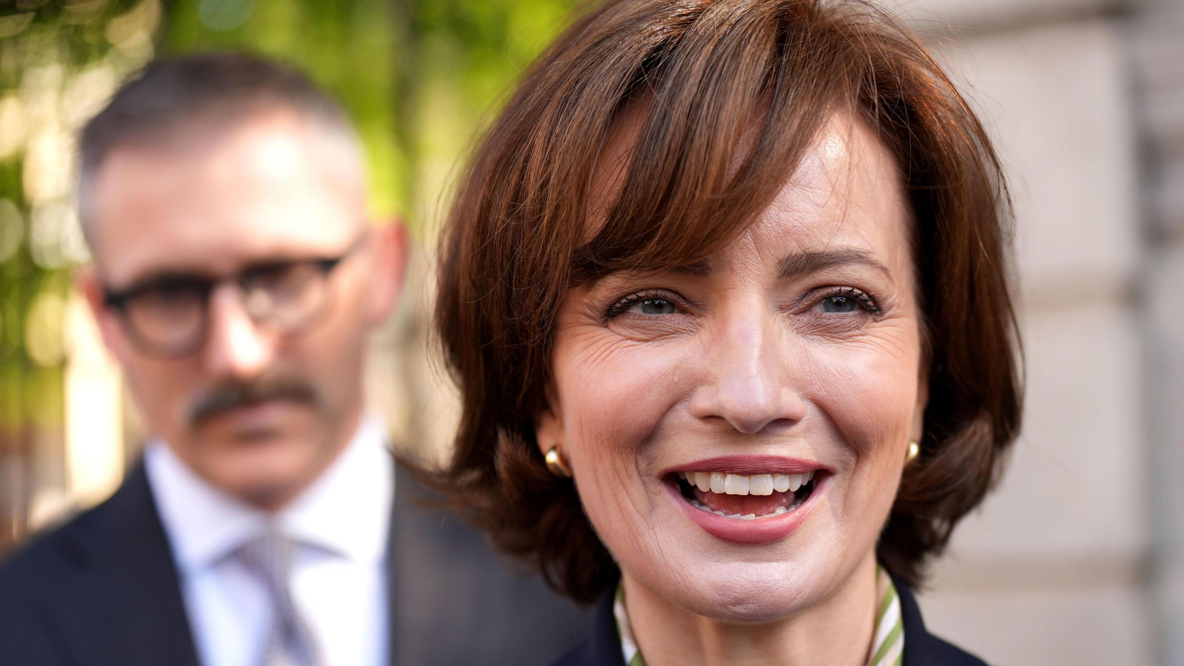 Independent presidential candidate Maria Steen is smiling and looking to the right of the frame. She has brown hair cut into a bob style.