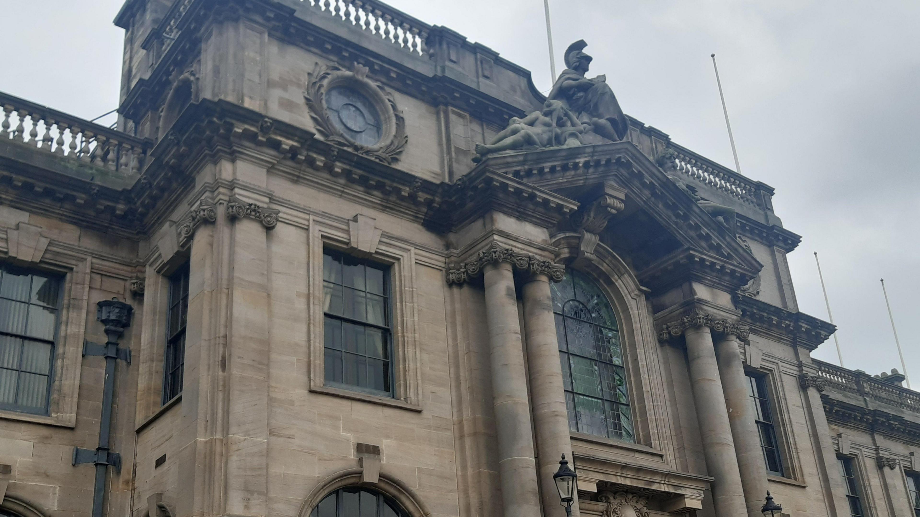 South Shields Town Hall, an elaborate and elegantly designed building with tall windows, carved pillars, and a sculpted depiction of a knight atop an arched roof.