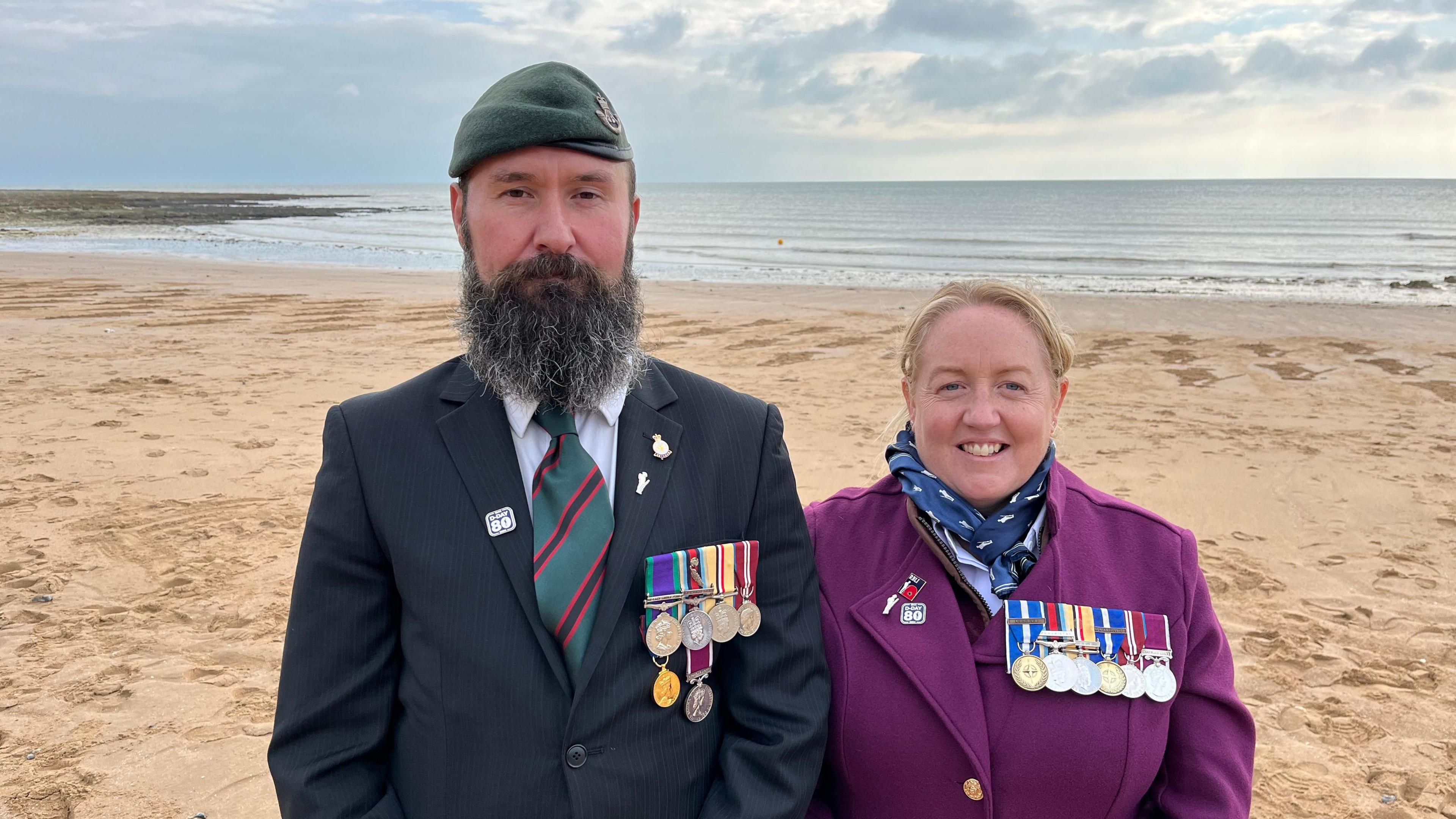 Matthew Whitehouse and Vicky McLennan on the beach in front of the silhouettes