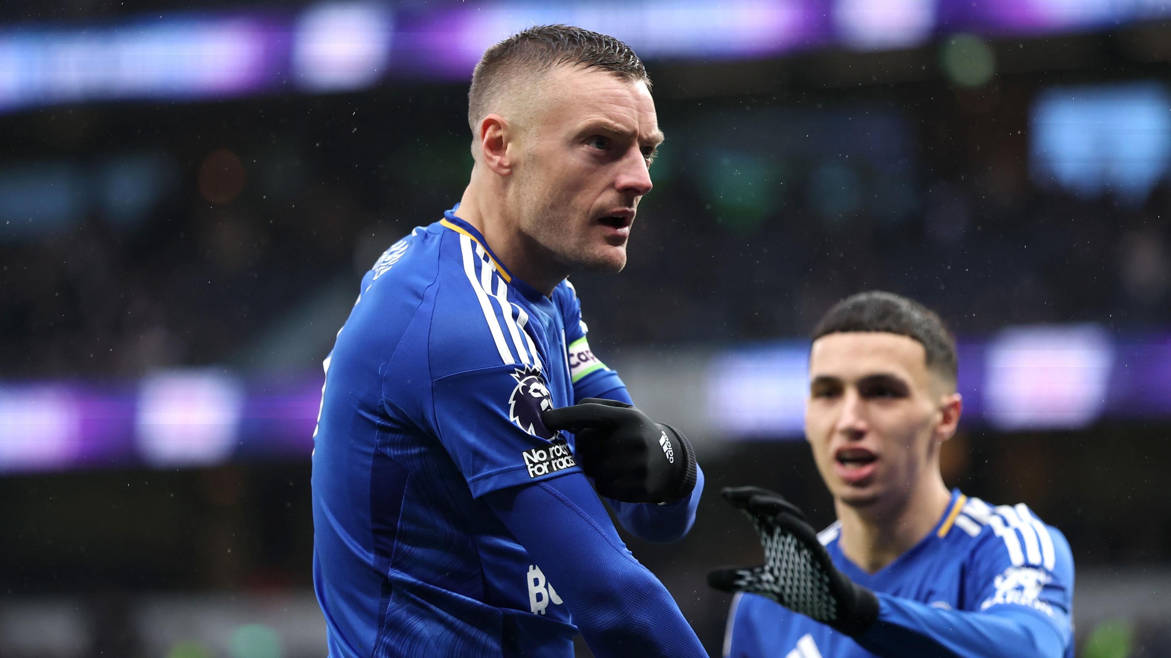 Jamie Vardy points at Premier League badge