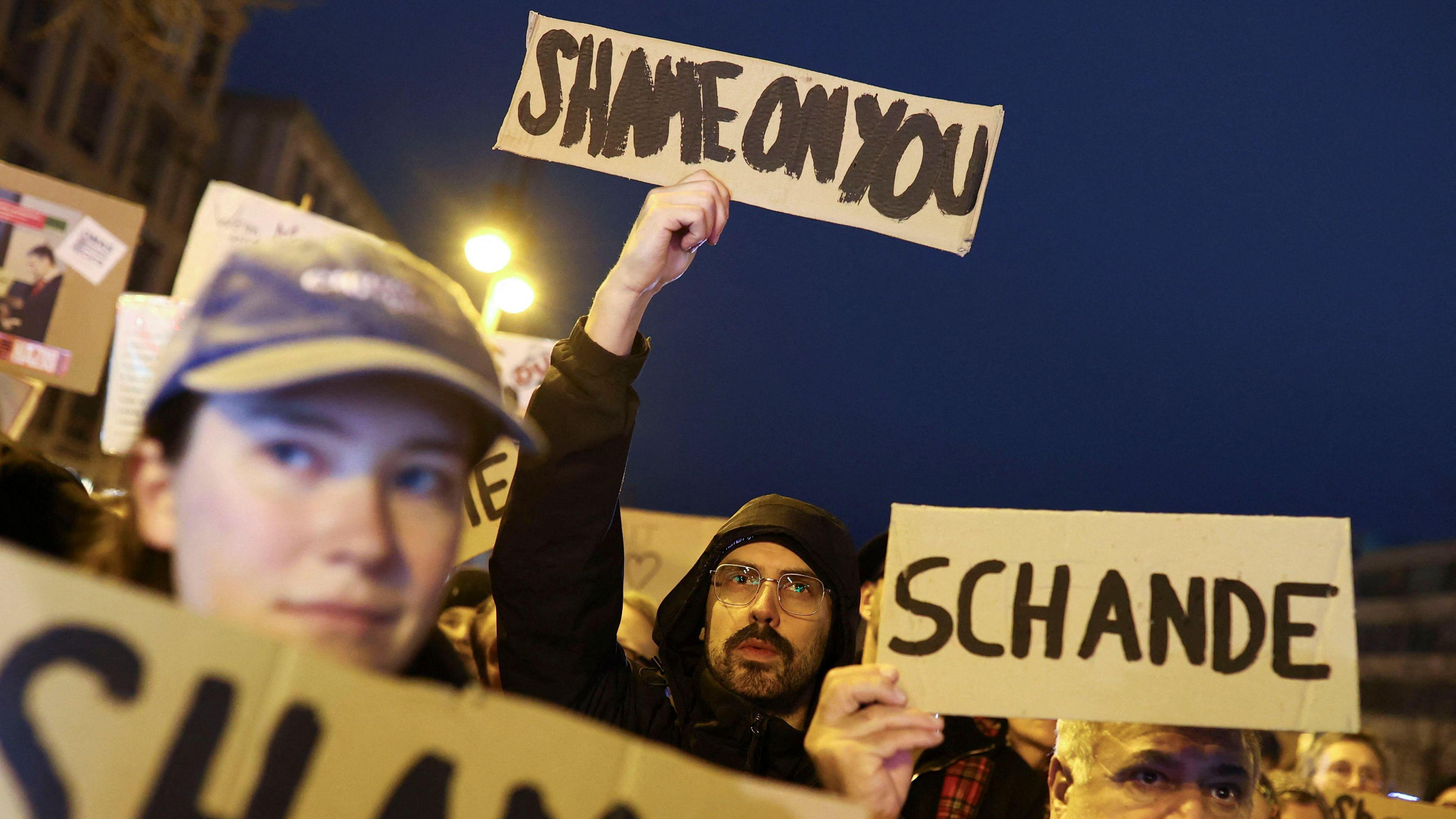 Activists protest against conservative German chancellor candidate Friedrich Merz's migration plans