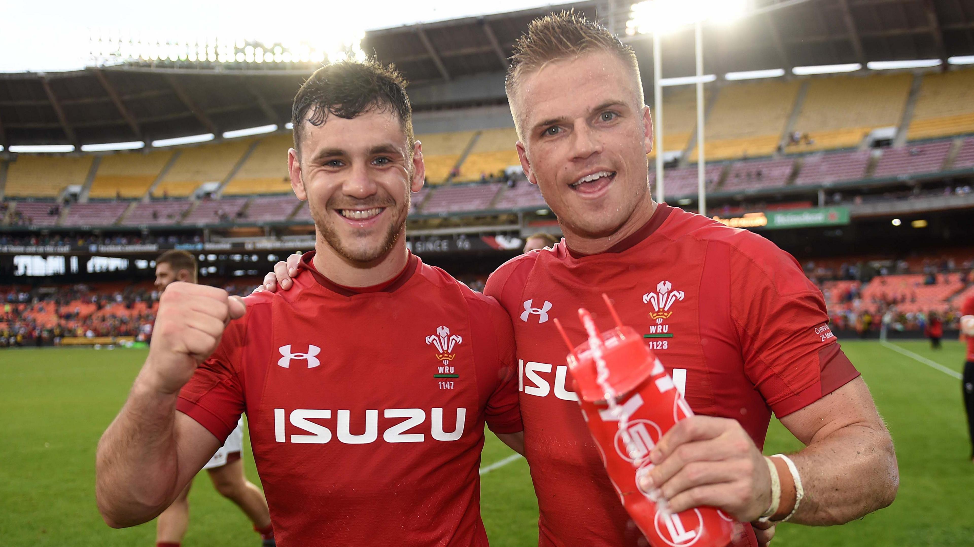 Tomos Williams (left) and Gareth Anscombe pinch their arms astir each different pursuing a Wales triumph successful 2018